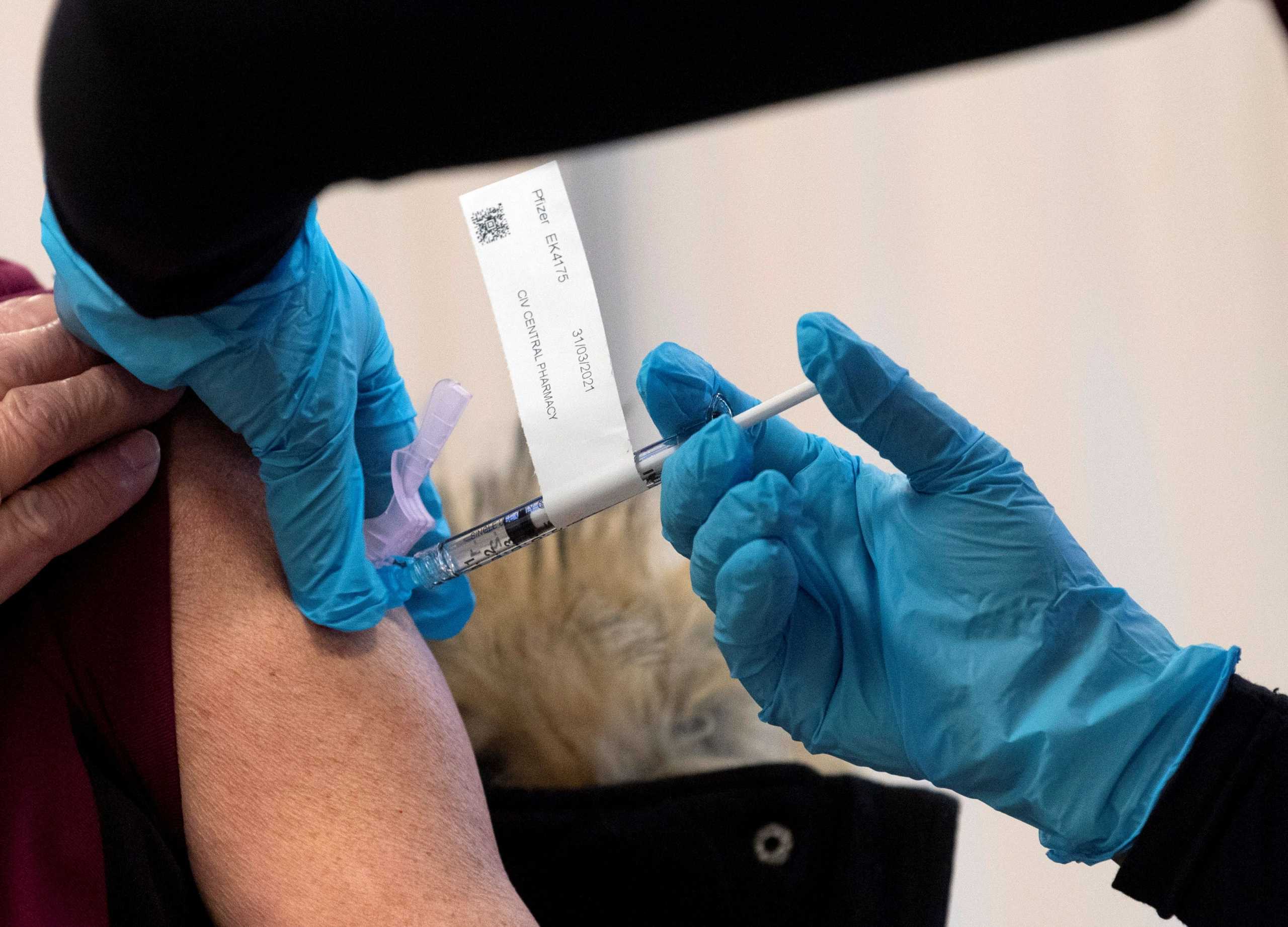 The Pfizer-BioNTech COVID-19 vaccine is administered to a personal support worker at the Civic Hospital in Ottawa, Ontario, Canada December 15, 2020. Adrian Wyld