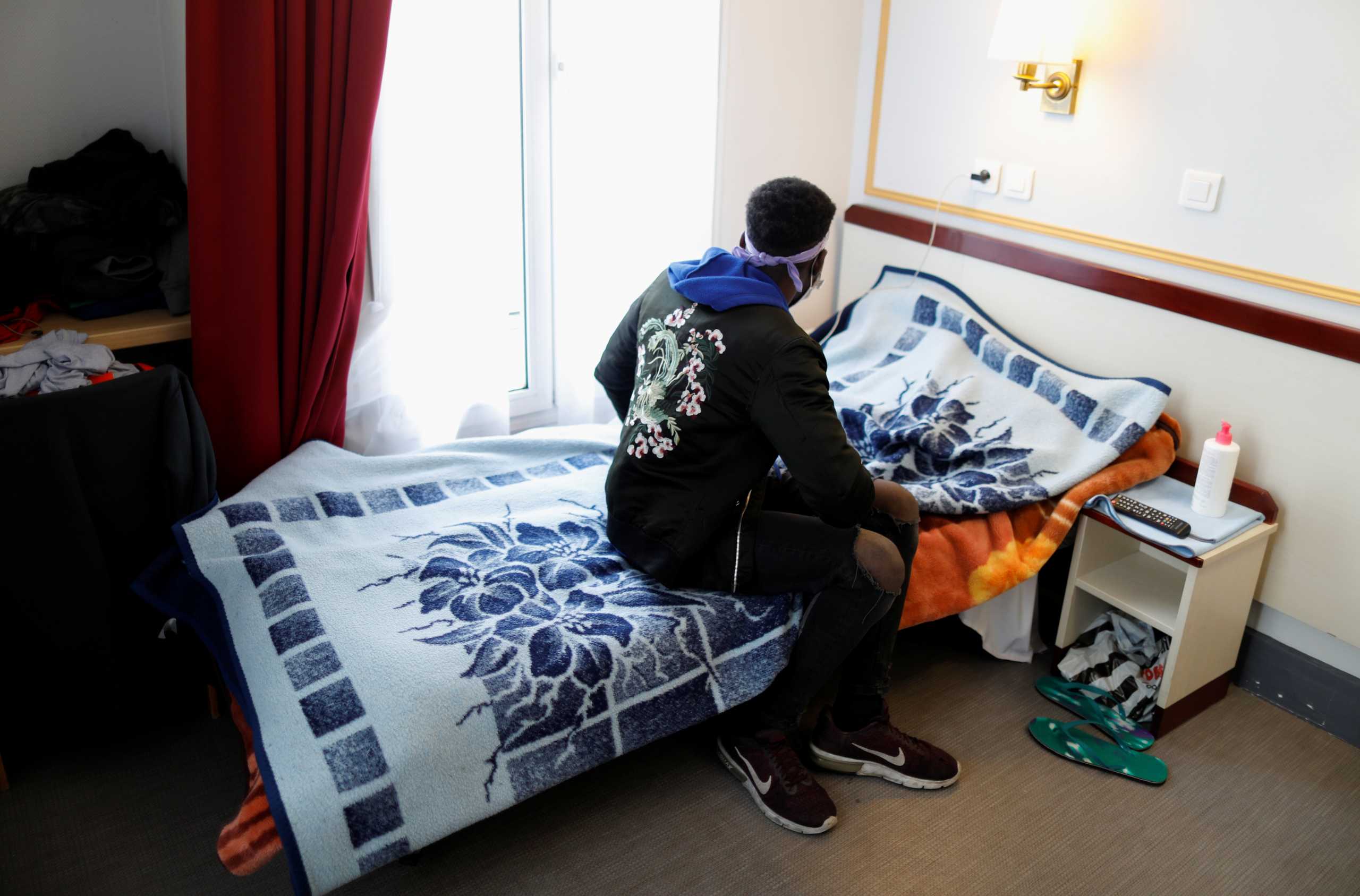 Asylum-seeker Ibrahim stands in his room at the Hotel Avenir Montmartre in Paris, France, December 2, 2020. The hotel, deserted by tourists due to COVID-19 travel bans opens its 42 rooms to the city's homeless for 12 months with the help of French charity association Emmaus Solidarite. Picture taken December 2, 2020.  REUTERS