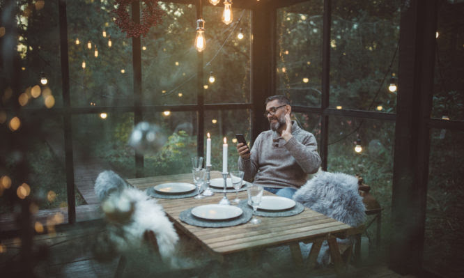 Mature men celebrating Christmas alone during his coronavirus self-isolation period.