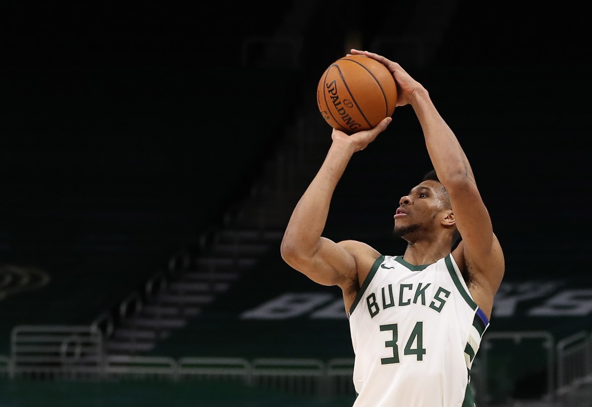 Jan 6, 2021; Milwaukee, WI, USA;  Milwaukee Bucks forward Giannis Antetokounmpo (34) shoots against Detroit Pistons forward Blake Griffin (23) at the Bradley Center.  Mandatory Credit: Nick Monroe