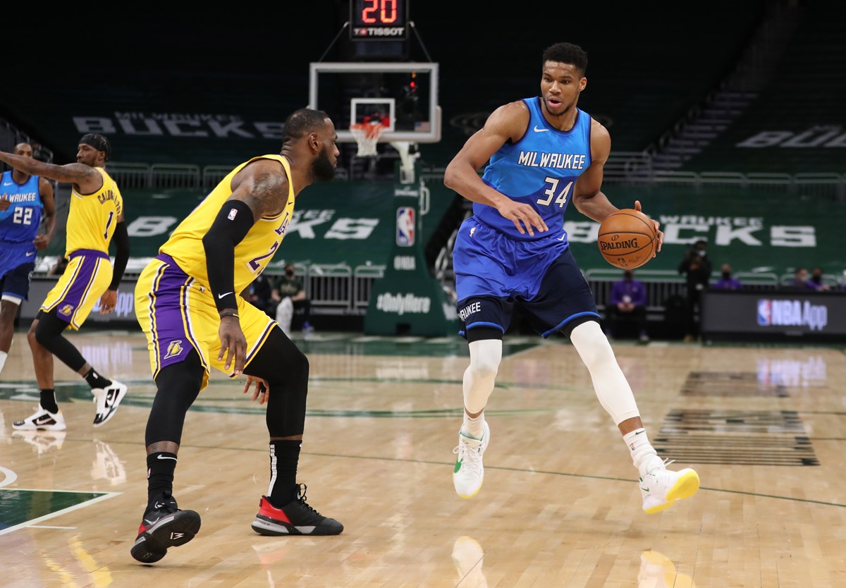 Jan 21, 2021; Milwaukee, WI, USA;  Milwaukee Bucks forward Giannis Antetokounmpo (34) is defended by Los Angeles Lakers forward LeBron James (23) at the Bradley Center.  Mandatory Credit: Nick Monroe