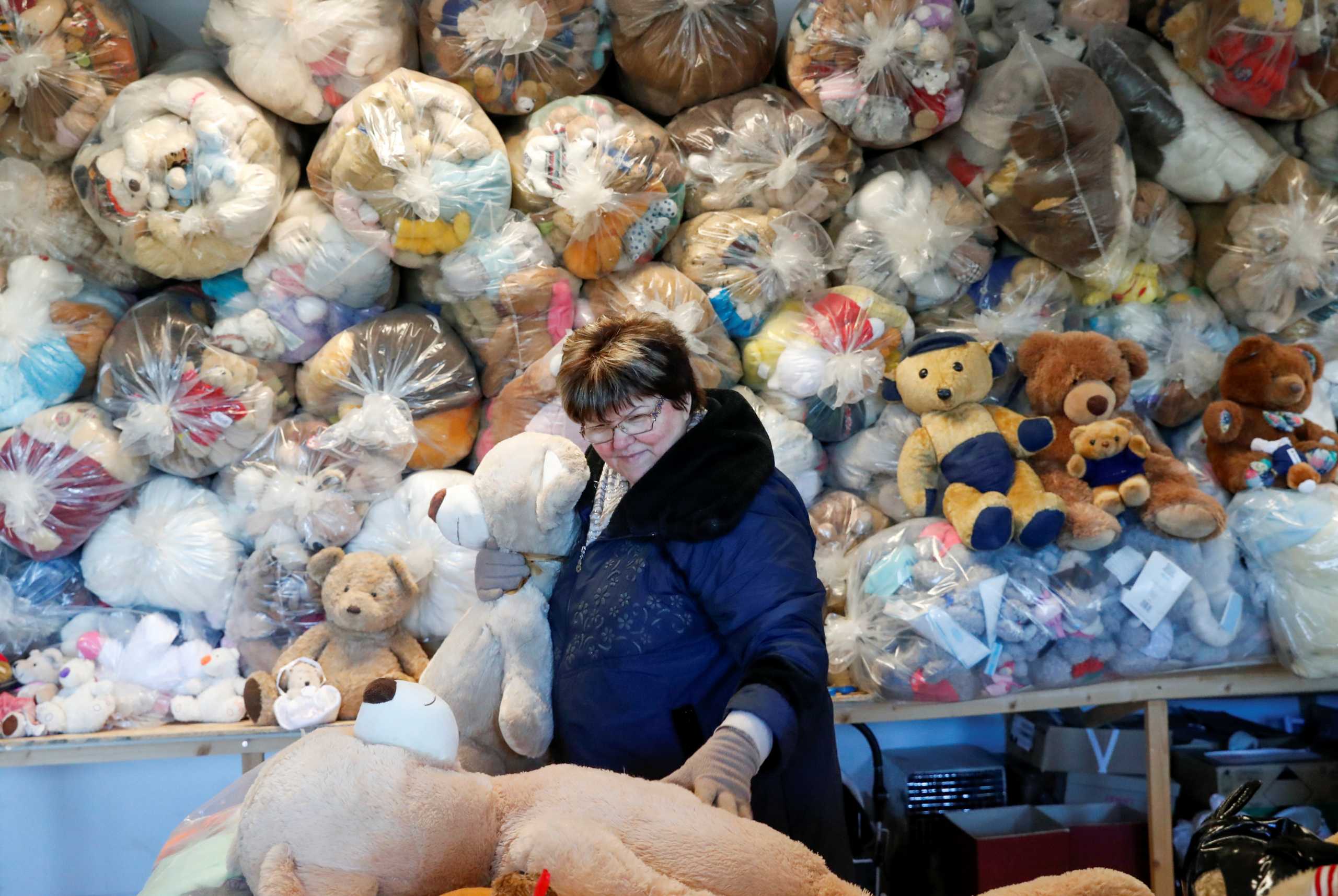 Valeria Schmidt, nicknamed as "Teddy Bear Mama", hugs a teddy bear in Harsany, Hungary, January 11, 2021. Picture taken January 11, 2021. REUTERS