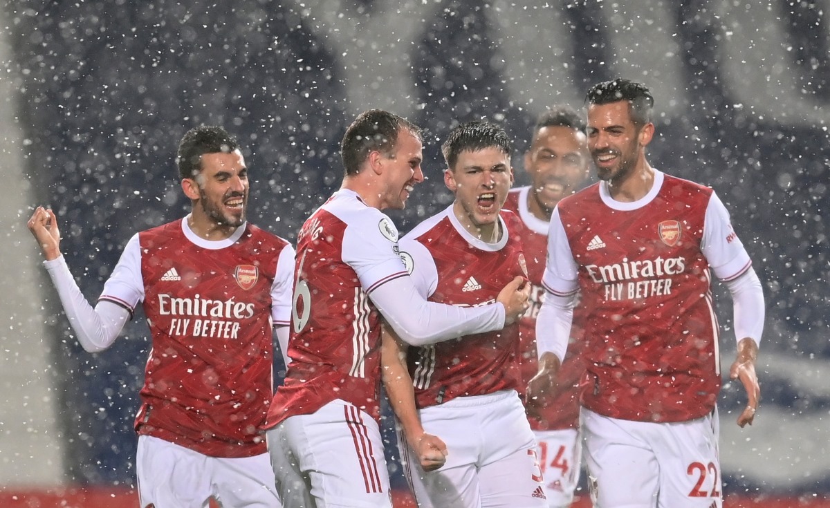 Soccer Football - Premier League - West Bromwich Albion v Arsenal - The Hawthorns, West Bromwich, Britain - January 2, 2021  Arsenal's Kieran Tierney celebrates scoring their first goal with teammates Pool via REUTERS