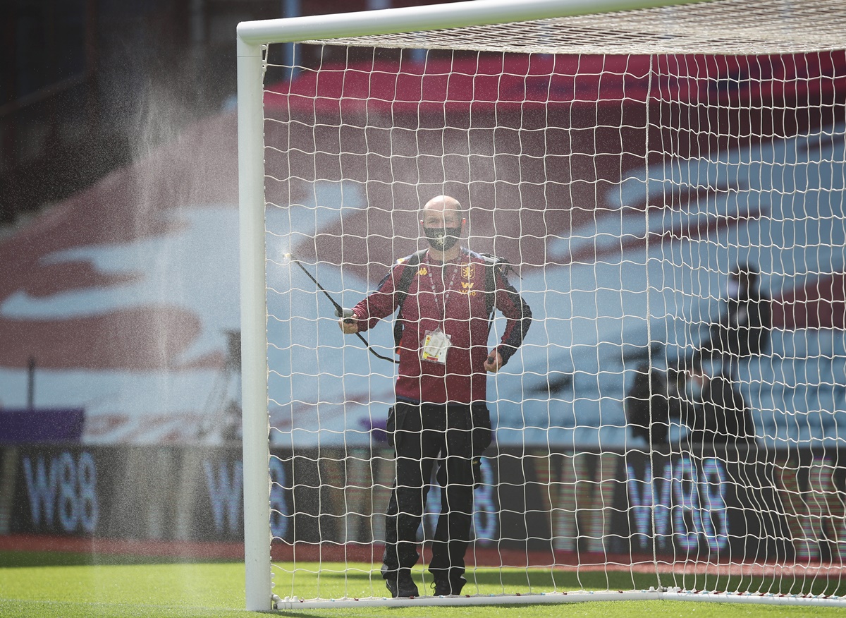 FILE PHOTO: Soccer Football - Premier League - Aston Villa v Chelsea - Villa Park, Birmingham, Britain - June 21, 2020 The goal posts are cleaned before the match, as play resumes behind closed doors following the outbreak of the coronavirus disease (COVID-19) REUTERS