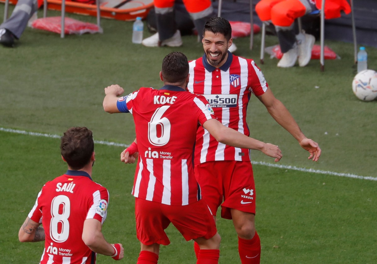 Soccer Football - La Liga Santander - Cadiz v Atletico Madrid - Estadio Ramon de Carranza, Cadiz, Spain - January 31, 2021 Atletico Madrid's Luis Suarez celebrates scoring their first goal with Koke REUTERS