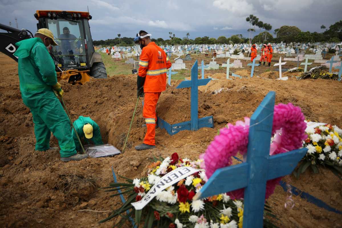 Gravediggers bury Joao Castro, 64, an indigenous man of the Satere Mawe ethnicity, after he passed away due to the coronavirus disease (COVID-19), at the Parque Taruma cemetery in Manaus, Brazil, January 8, 2021. REUTERS