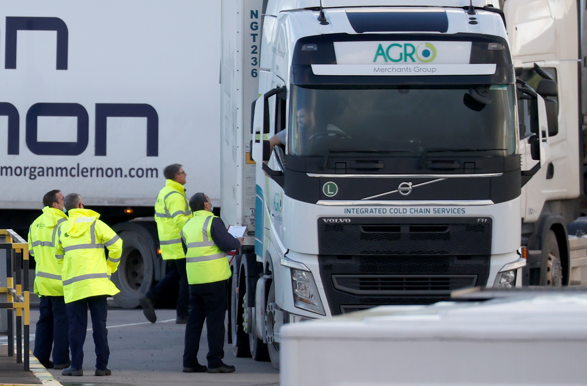 People inspect lorries which arrived at the Port of Larne, Northern Ireland Britain January 1, 2021. REUTERS