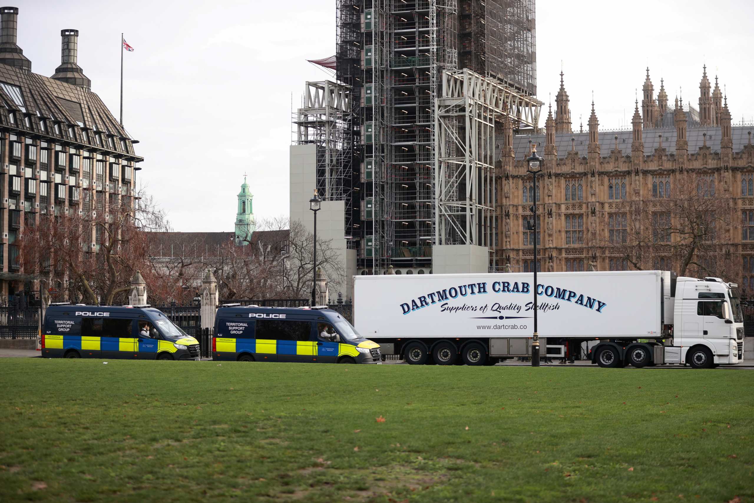 A lorry drives during a protest against post-Brexit bureaucracy that hinders exports to the European Union, as police officers in vans watch over the demonstration at the Parliament Square in London, Britain, January 18, 2021. REUTERS