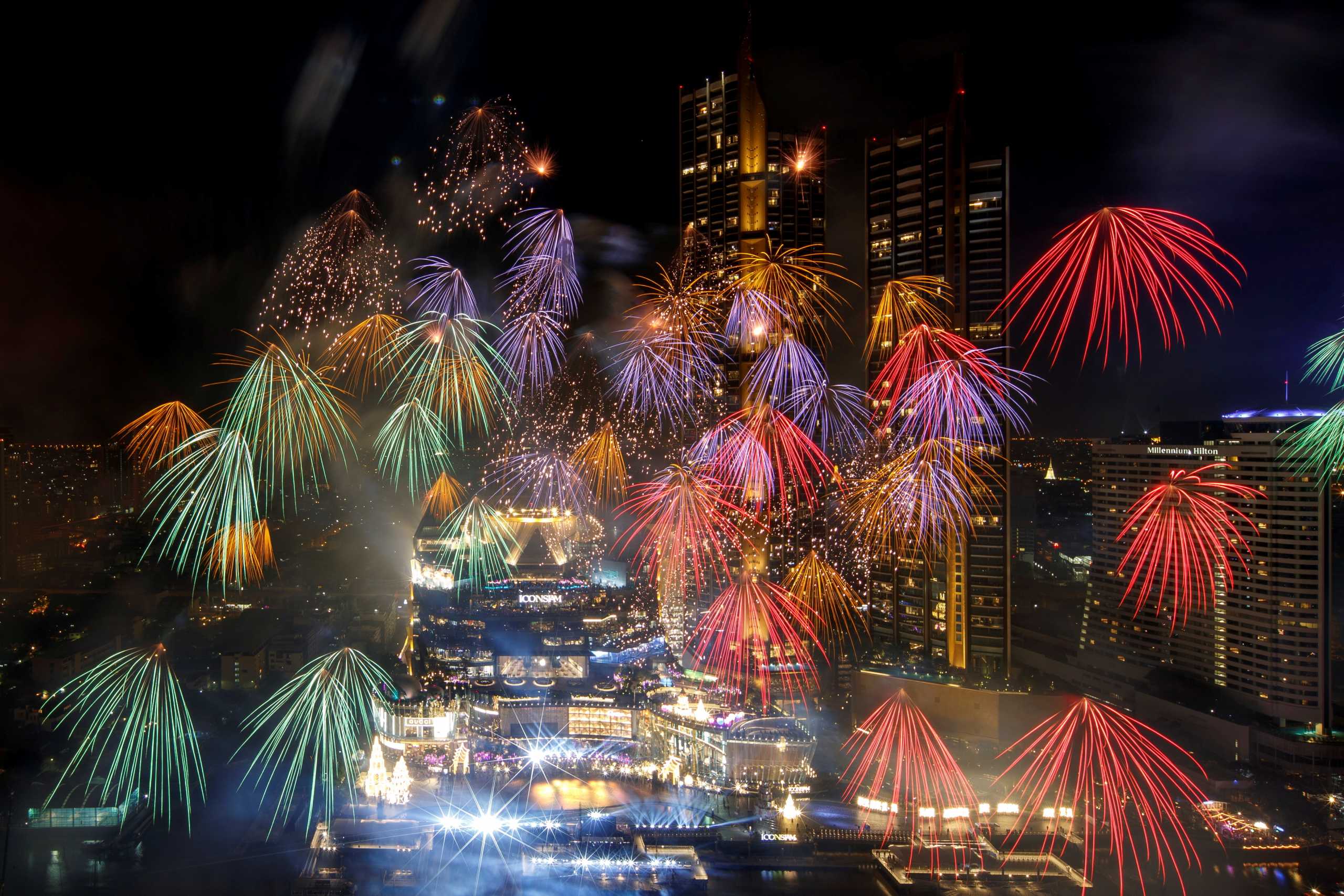 Fireworks explode over Chao Phraya River during the New Year celebrations amid the spread of the coronavirus disease (COVID-19) in Bangkok, Thailand, January 1, 2021. REUTERS