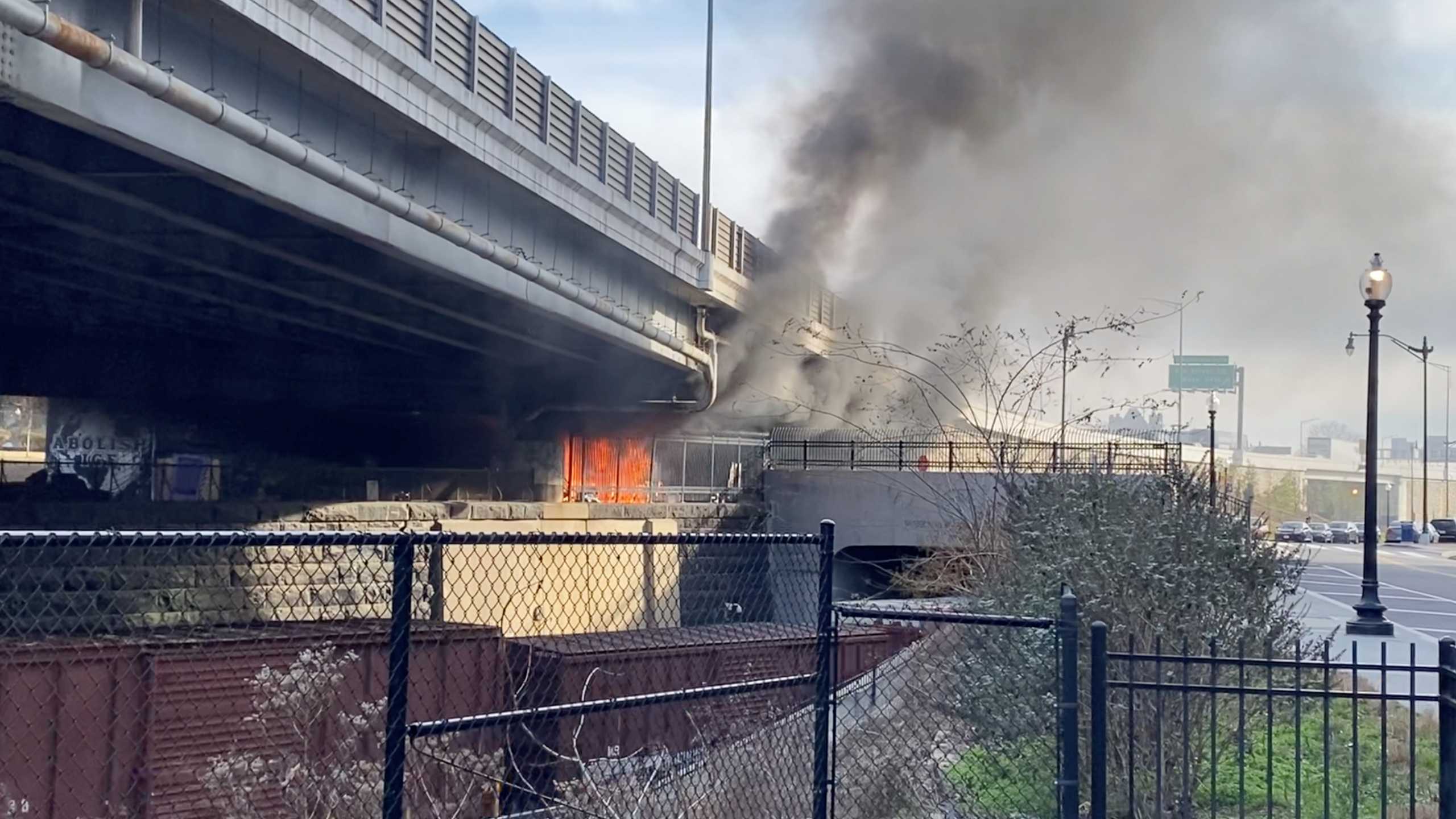 A fire burns under a bridge in Washington, DC, U.S. January 18, 2021, in this still image obtained from a social media video. Edward Daniels via REUTERS THIS IMAGE HAS BEEN SUPPLIED BY A THIRD PARTY. MANDATORY CREDIT. NO RESALES. NO ARCHIVES
