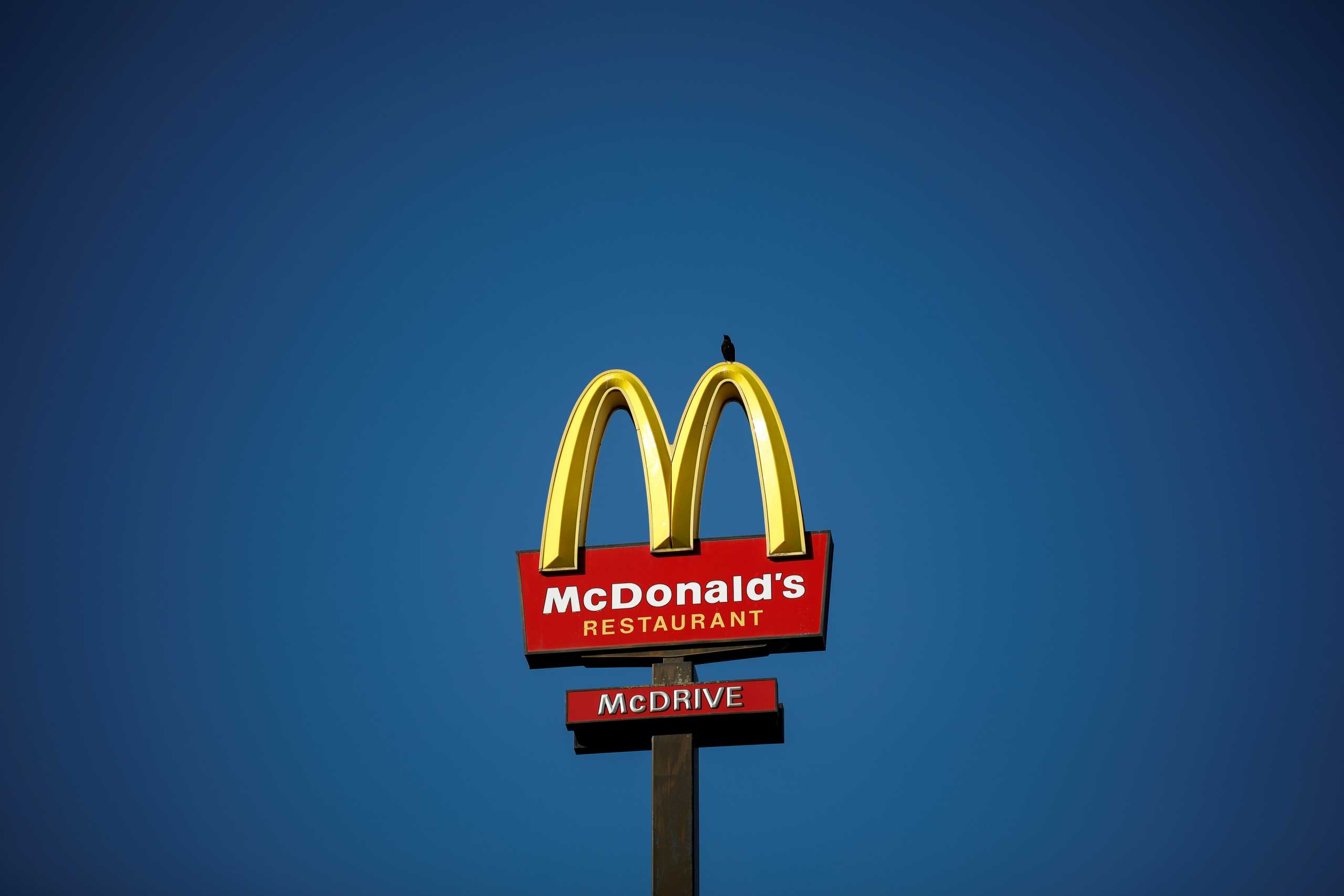 FILE PHOTO: The McDonald's company logo stands on a sign outside a restaurant in Bretigny-sur-Orge, near Paris, France, July 30, 2020. REUTERS