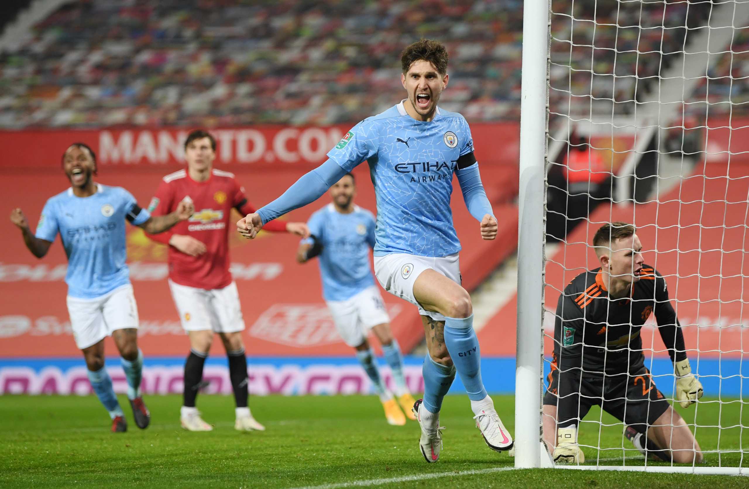 Soccer Football - Carabao Cup - Semi Final - Manchester United v Manchester City - Old Trafford, Manchester, Britain - January 6, 2021 Manchester City's John Stones celebrates scoring their first goal Pool via REUTERS