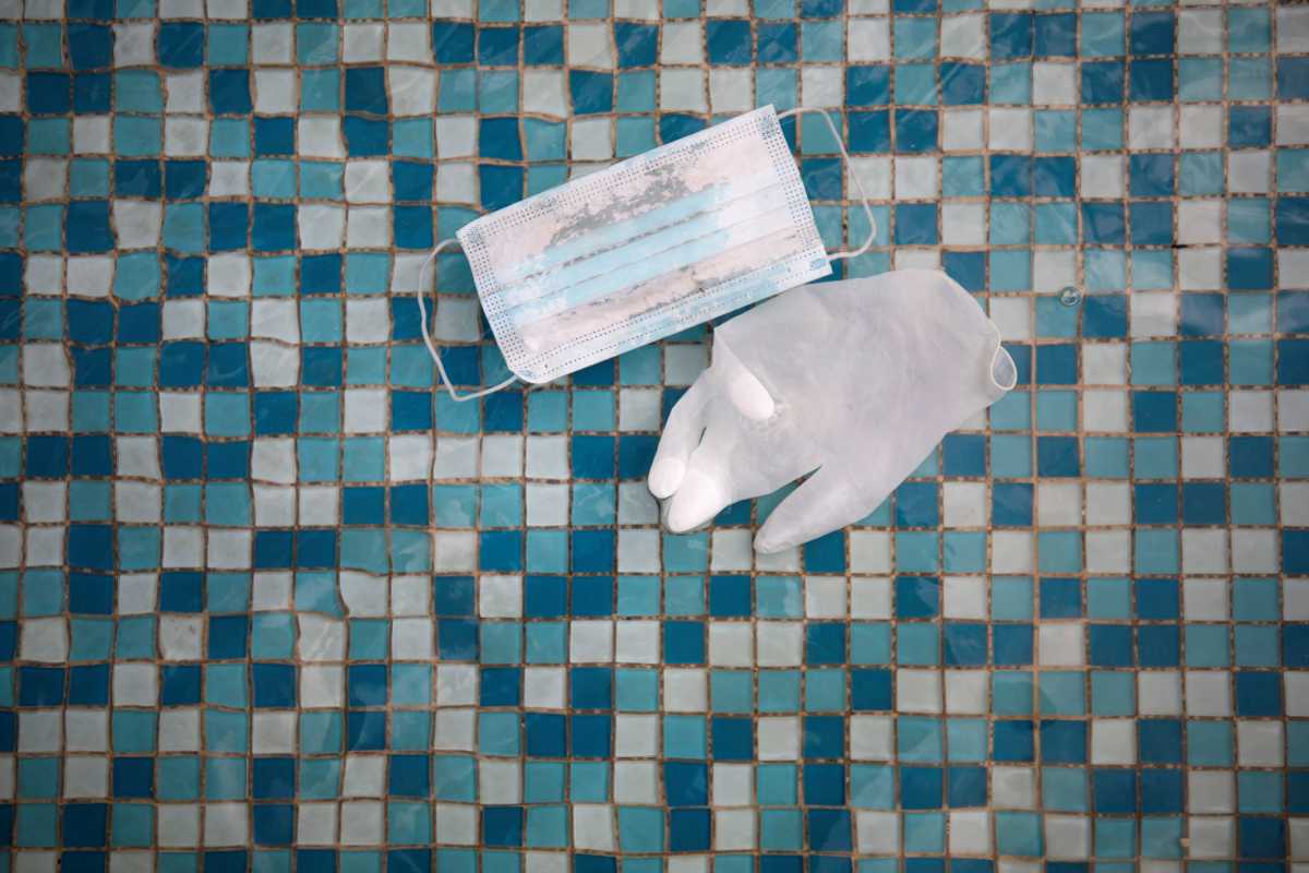 A glove and face mask float in a mosaic-covered water fountain amid Israel's third national lockdown to fight the coronavirus disease (COVID-19), in Ashkelon, Israel January 20, 2021. REUTERS