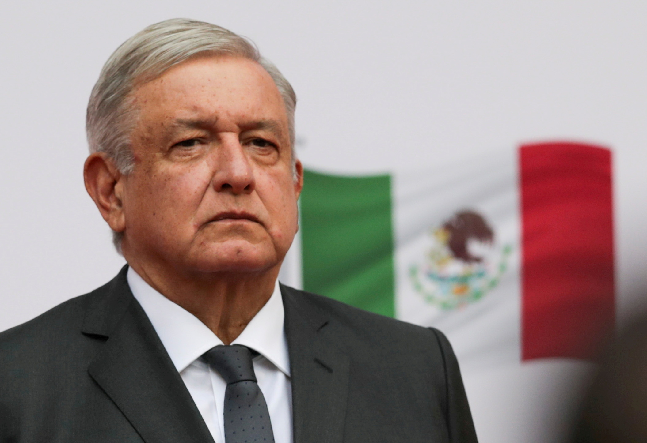 FILE PHOTO: Mexico's President Andres Manuel Lopez Obrador listens to the national anthem as he arrives to address the nation on his second anniversary as President of Mexico, at the National Palace in Mexico City, Mexico, December 1, 2020. REUTERS