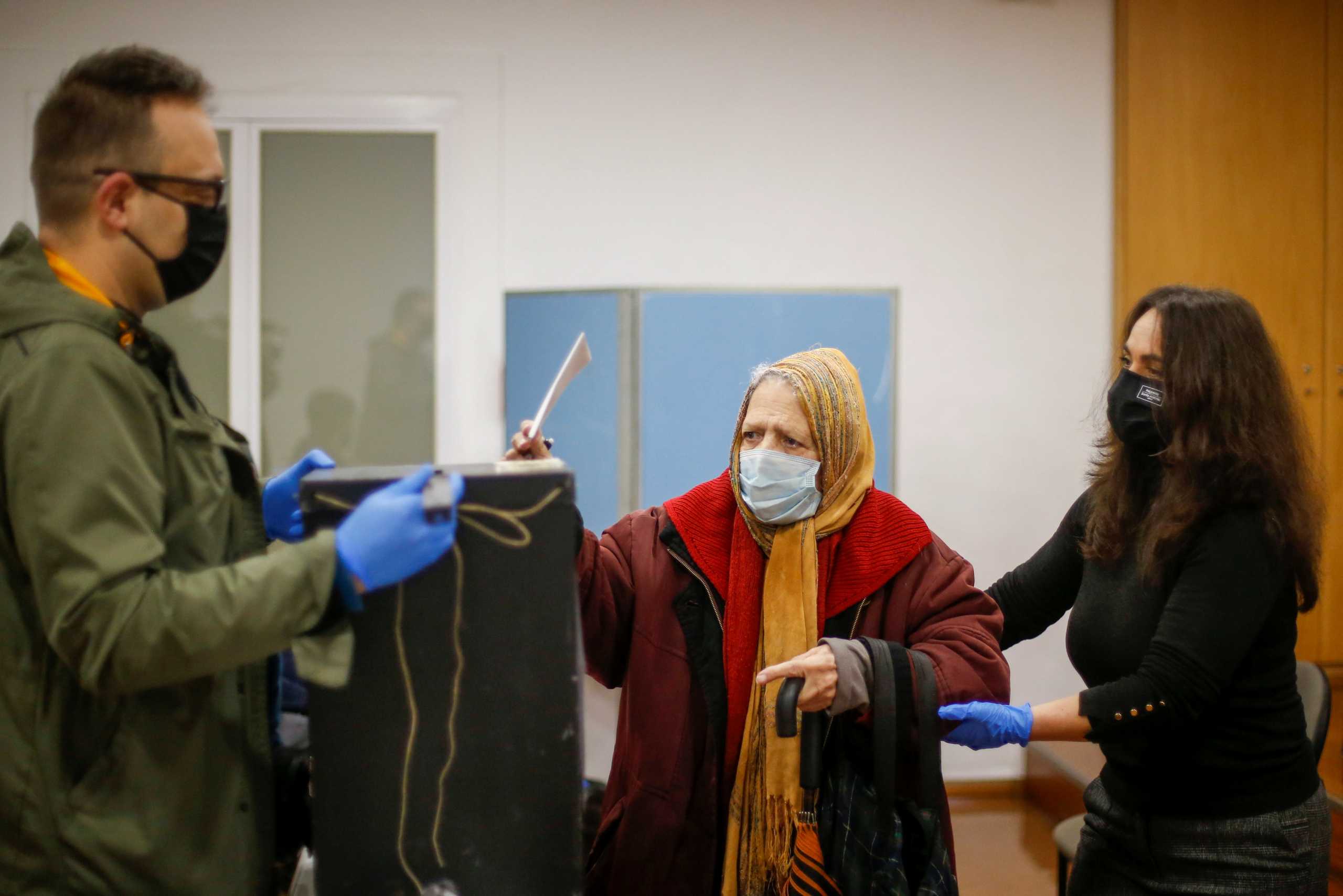 A woman wearing a protective mask casts her ballot for Portugal's presidential election, amid the coronavirus disease (COVID-19) pandemic in Lisbon, Portugal, January 24, 2021. REUTERS