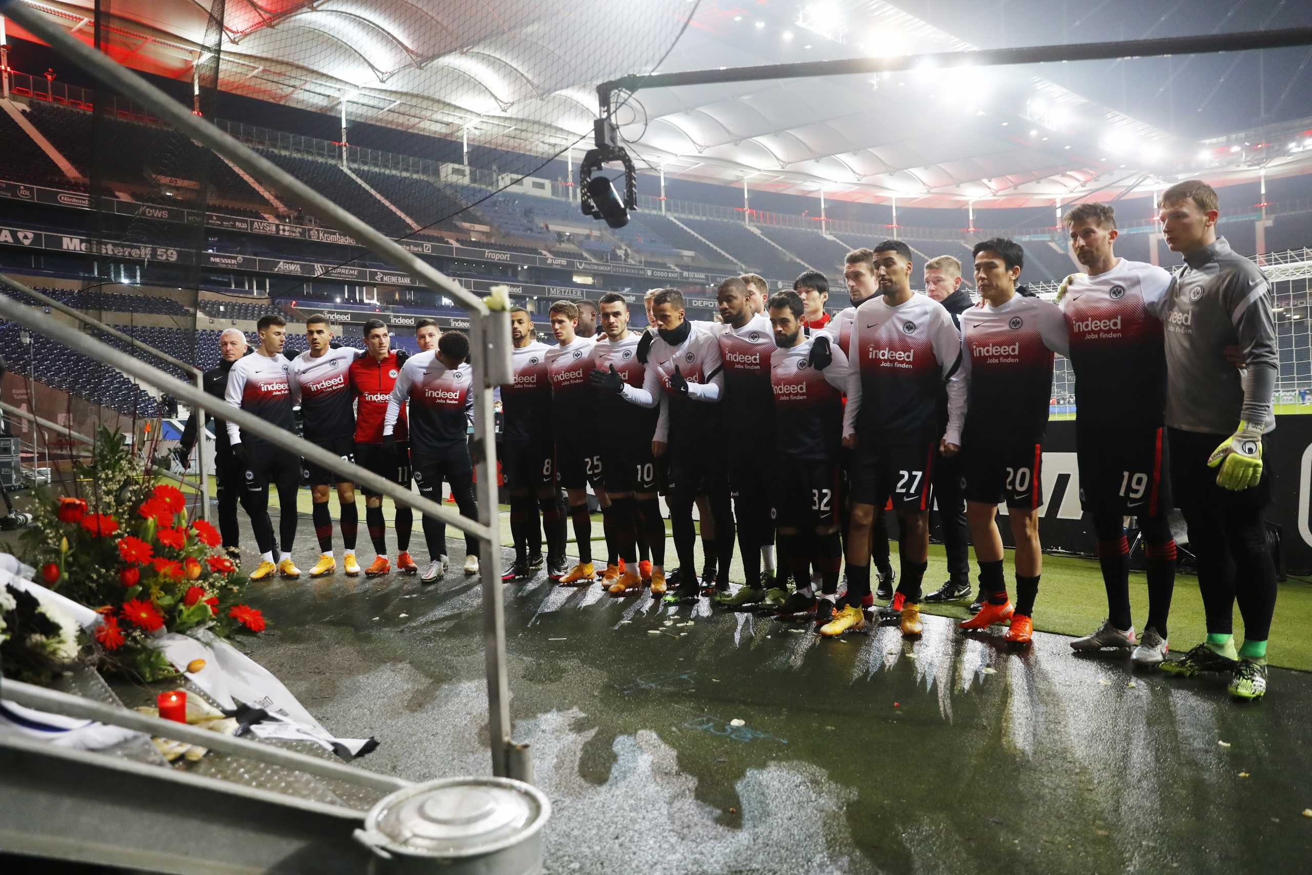 Soccer Football - Bundesliga - Eintracht Frankfurt v Schalke 04 - Deutsche Bank Park, Frankfurt, Germany - January 17, 2021 Eintracht Frankfurt players commemorate a fan in front of tributes placed inside the stadium before the match Pool via REUTERS