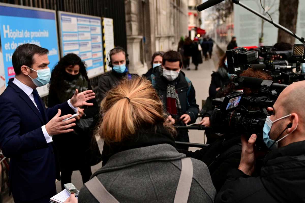 French Health Minister Olivier Veran speaks to the media as he arrives to attend the vaccination of health workers, at the vaccination centre of Hotel Dieu (Assistance Publique - Hopitaux de Paris) in Paris, France January 4, 2021, as part of the launch of the vaccination campaign for healthcare professionals over 50 and