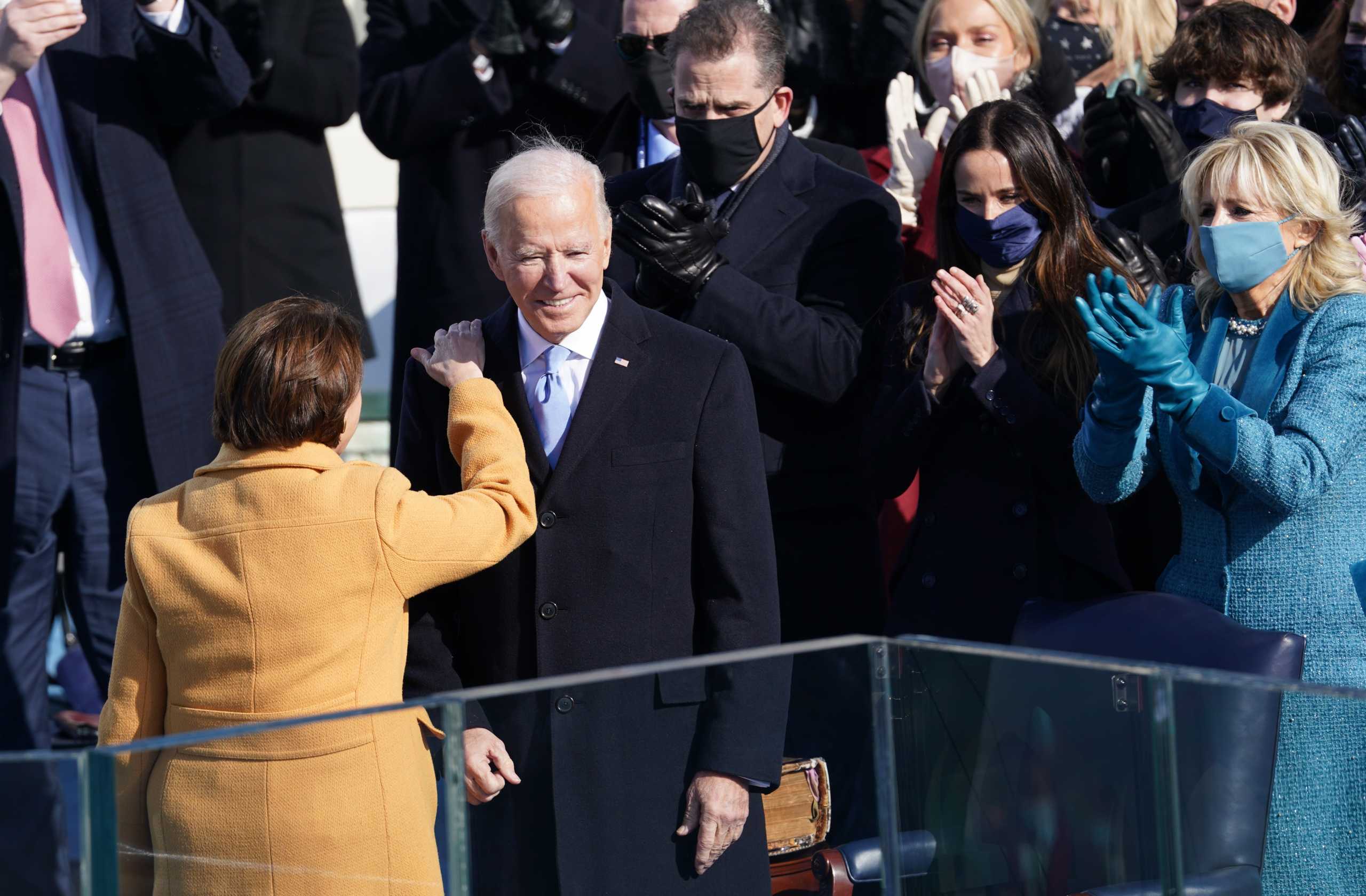 U.S. President Joe Biden talks to Sen. Amy Klobuchar (D-MN) during the inauguration of Biden as the 46th President of the United States on the West Front of the U.S. Capitol in Washington, U.S., January 20, 2021. REUTERS