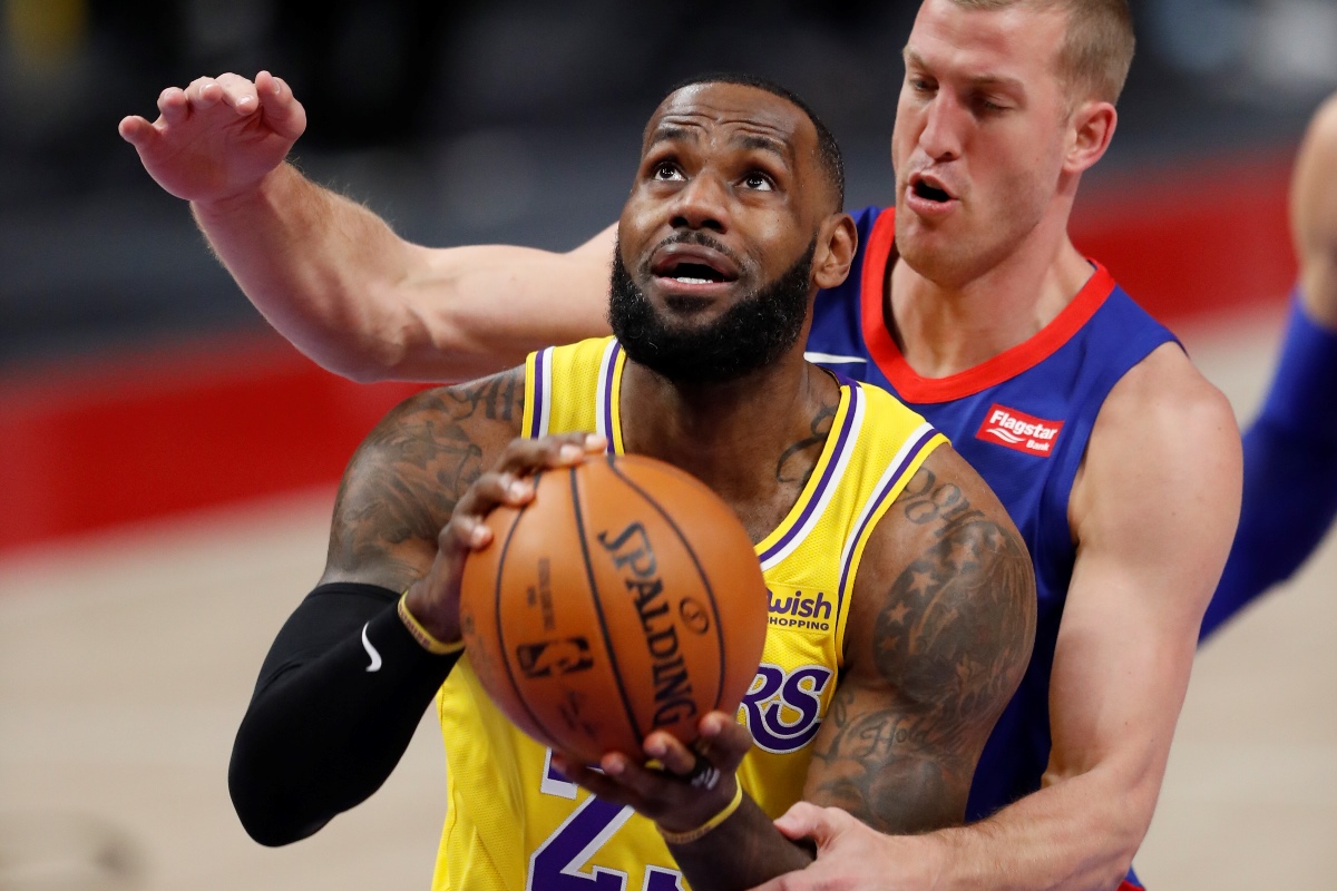Jan 28, 2021; Detroit, Michigan, USA; Los Angeles Lakers forward LeBron James (23) gets fouled by Detroit Pistons center Mason Plumlee (24) during the first quarter at Little Caesars Arena. Mandatory Credit: Raj Mehta-USA TODAY Sports