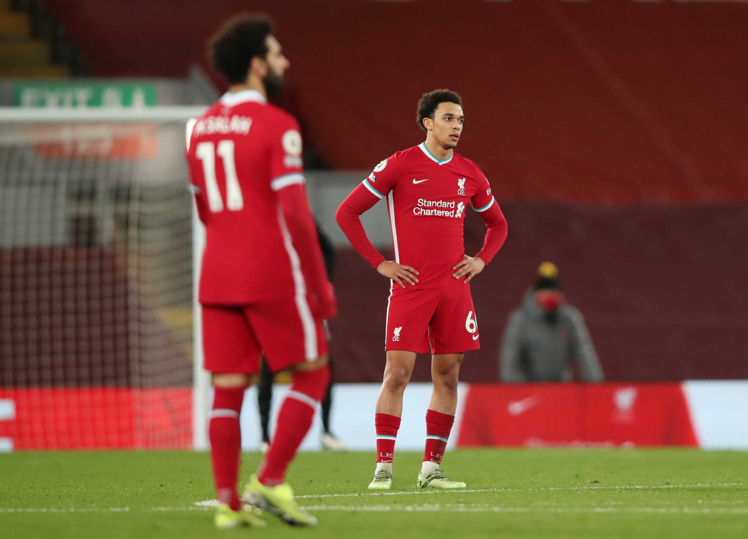 Soccer Football - Premier League - Liverpool v Burnley - Anfield, Liverpool, Britain - January 21, 2021 Liverpool's Mohamed Salah and Trent Alexander-Arnold look dejected after Ashley Barnes scored Burnley's first goal with a penalty Pool via REUTERS
