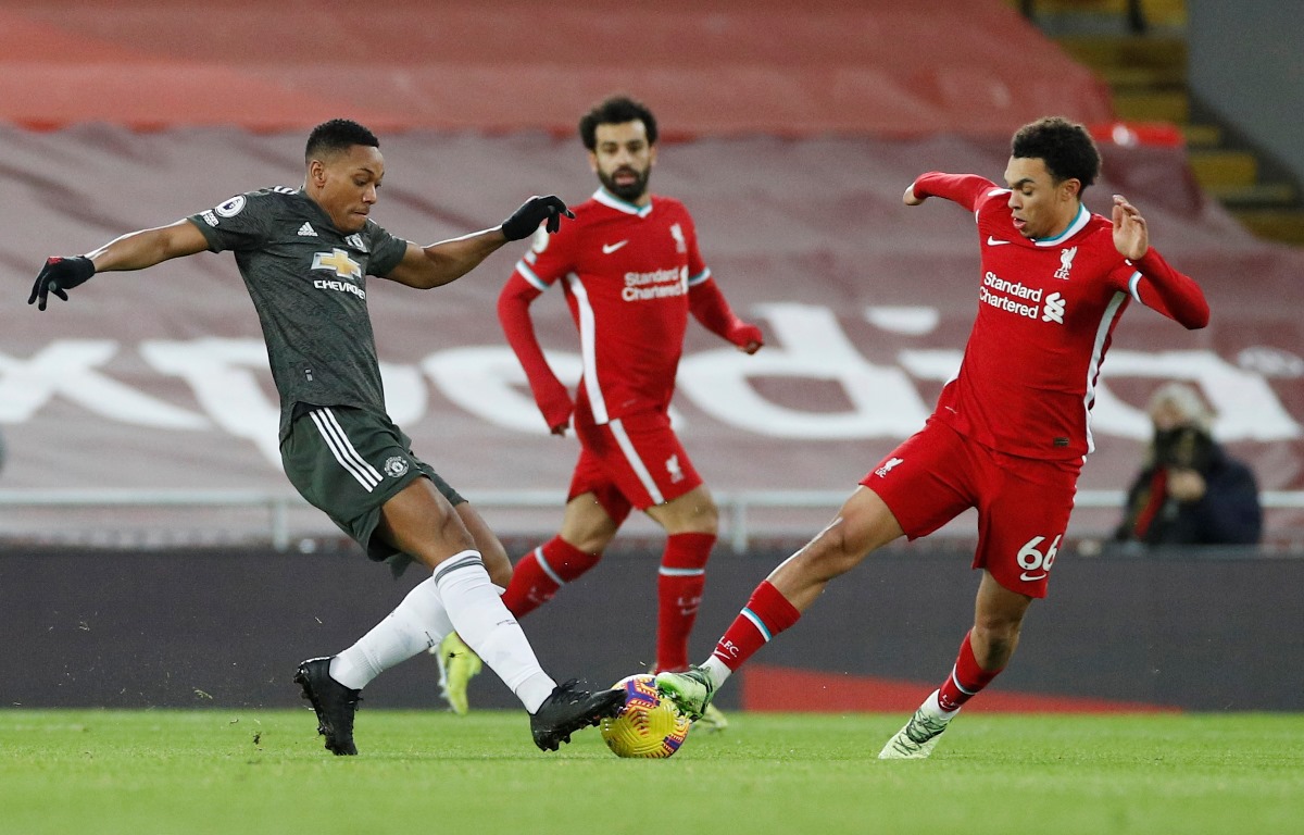 Soccer Football - Premier League - Liverpool v Manchester United - Anfield, Liverpool, Britain - January 17, 2021   Liverpool's Trent Alexander-Arnold in action with Manchester United's Anthony Martial Pool via REUTERS
