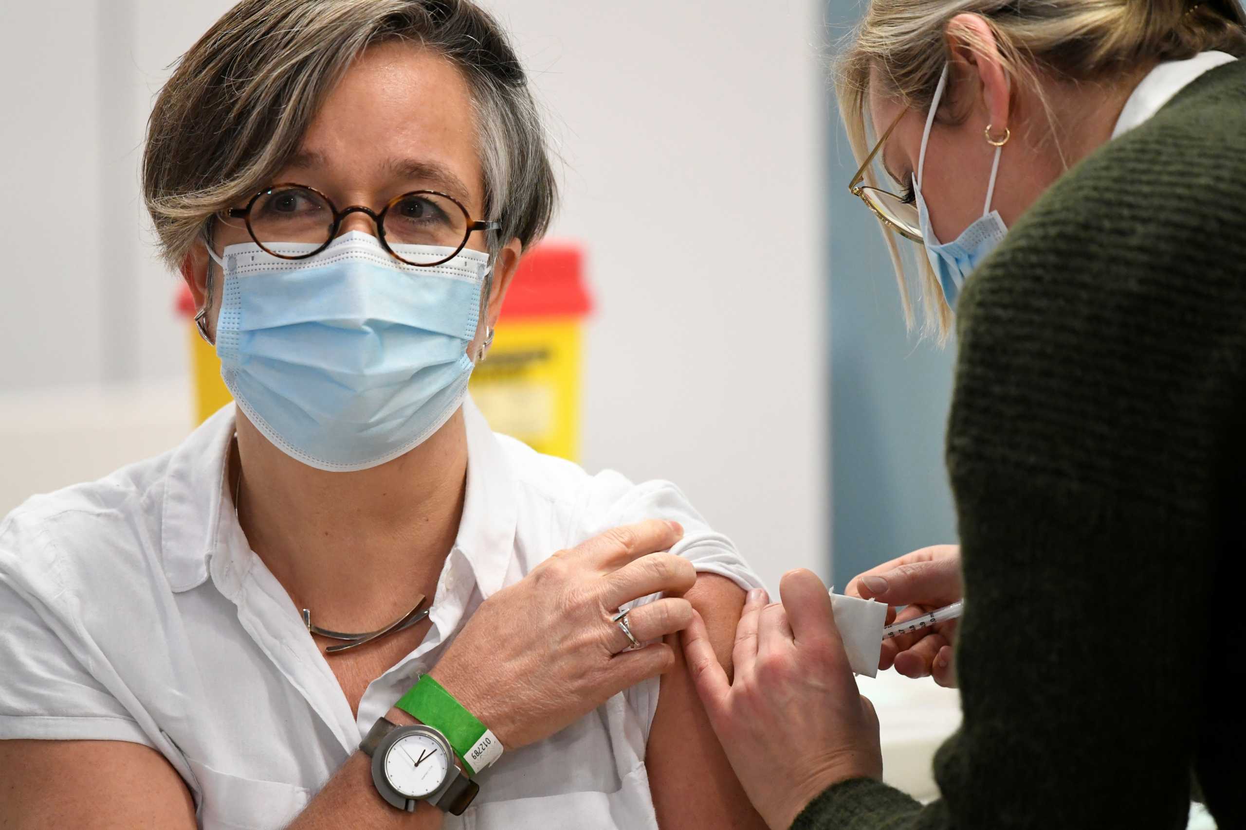 A healthcare worker receives the Pfizer