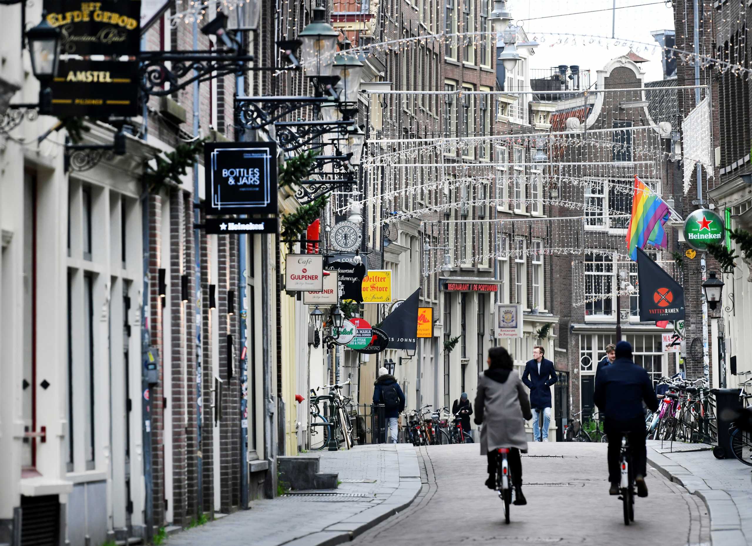 People ride bikes on an empty street as Netherlands has gone into lockdown as the spread of the coronavirus disease (COVID-19) continues in Amsterdam, Netherlands December 15 2020, REUTERS