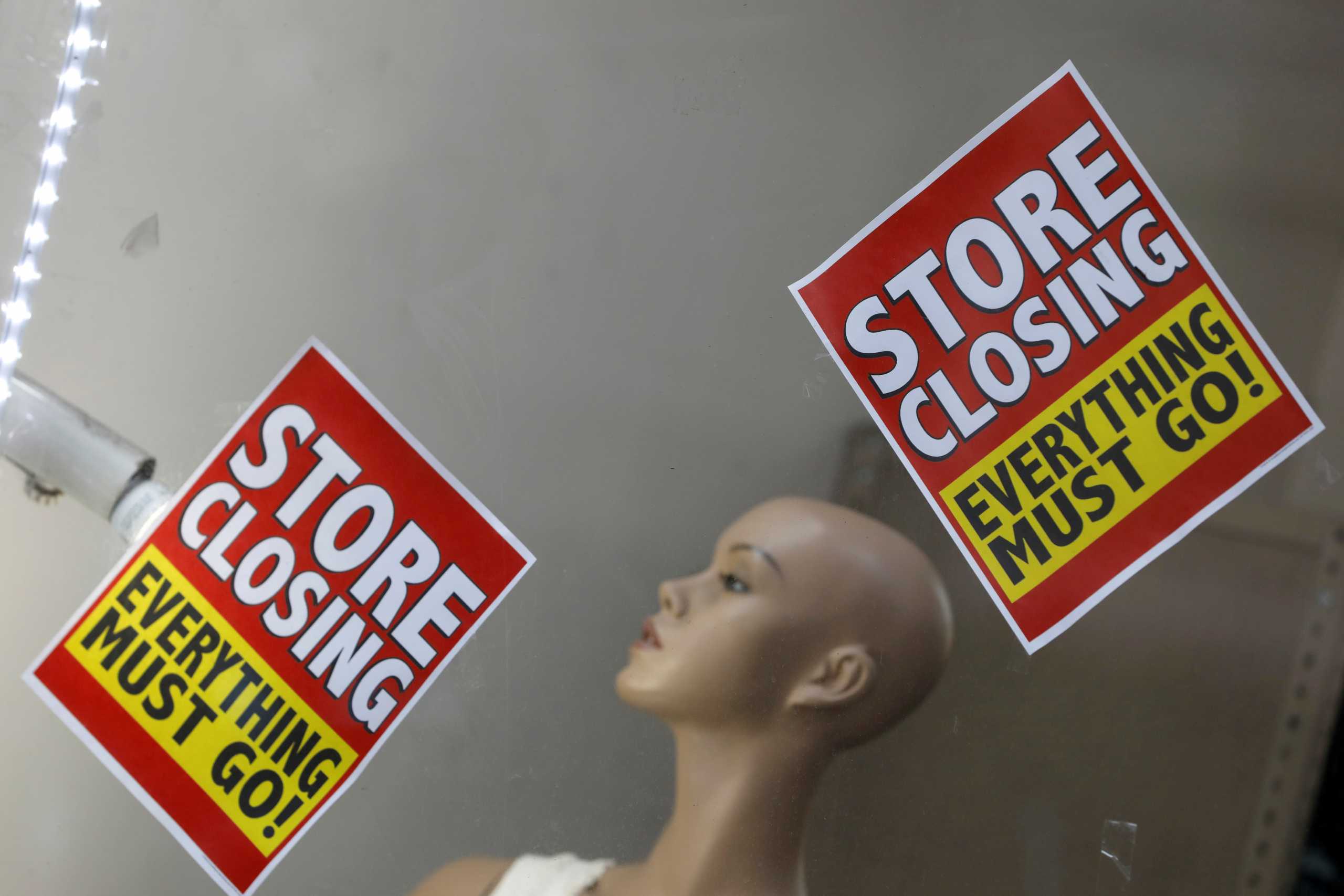 FILE PHOTO: Signage is seen advertising a sale at a store that is closing in Manhattan, New York City, U.S., August 17, 2020. REUTERS