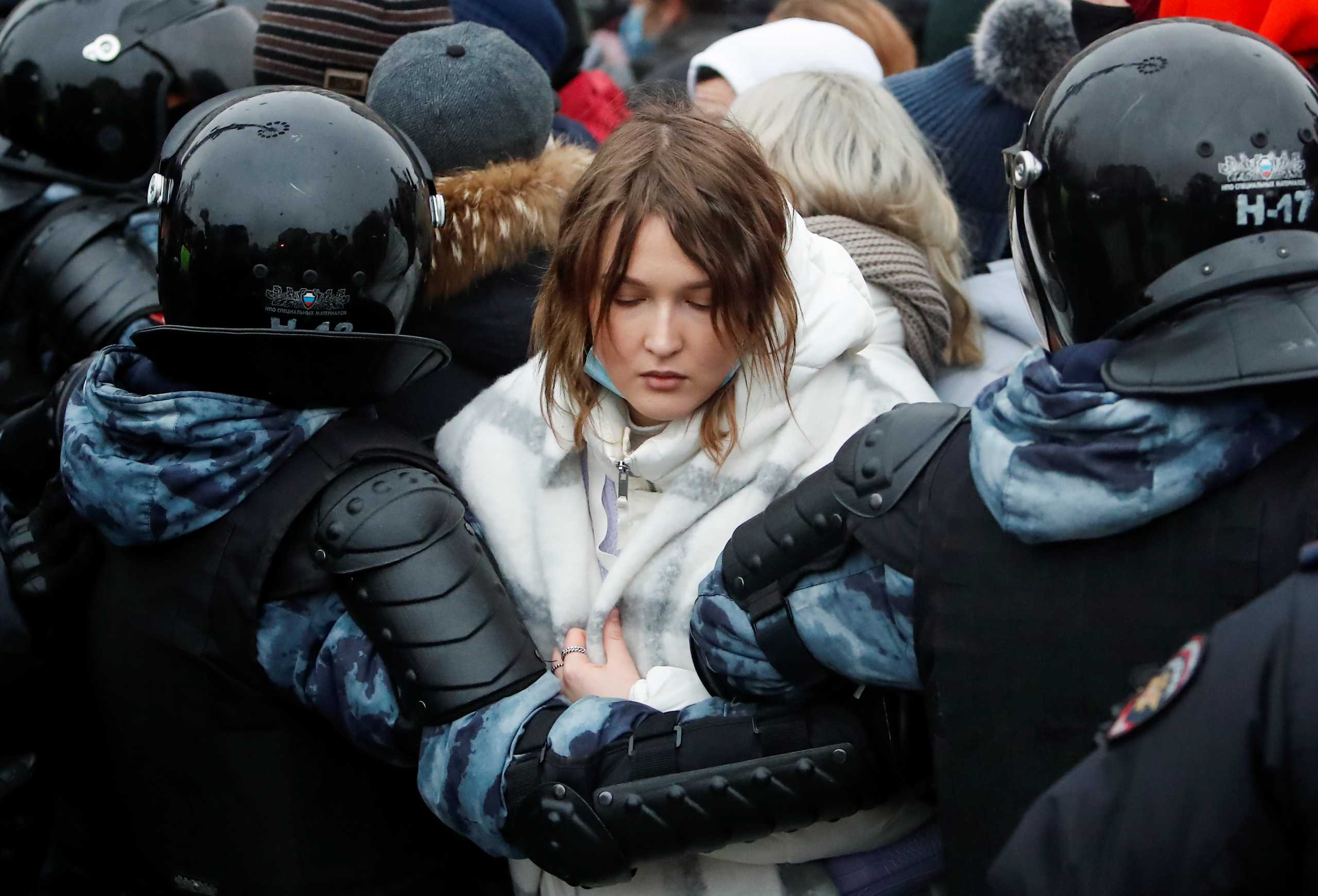 Law enforcement officers detain a woman during a rally in support of jailed Russian opposition leader Alexei Navalny in Moscow, Russia January 23, 2021. REUTERS