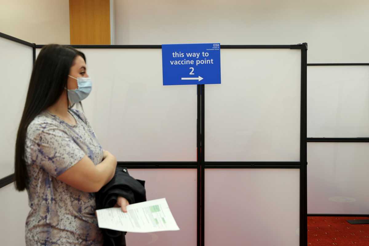 A woman stands waits to get vaccinated at the Centre for Life vaccination hub, amid the coronavirus disease (COVID-19) outbreak, in Newcastle, Britain January 11, 2021. REUTERS