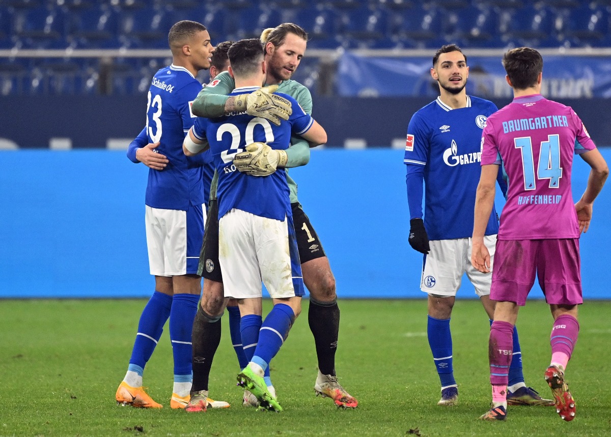 Soccer Football - Bundesliga - Schalke 04 v TSG 1899 Hoffenheim - Veltins-Arena, Gelsenkirchen, Germany - January 9, 2021 Schalke 04's Ralf Fahrmann and Sead Kolasinac celebrate at the end of the match Pool via REUTERS