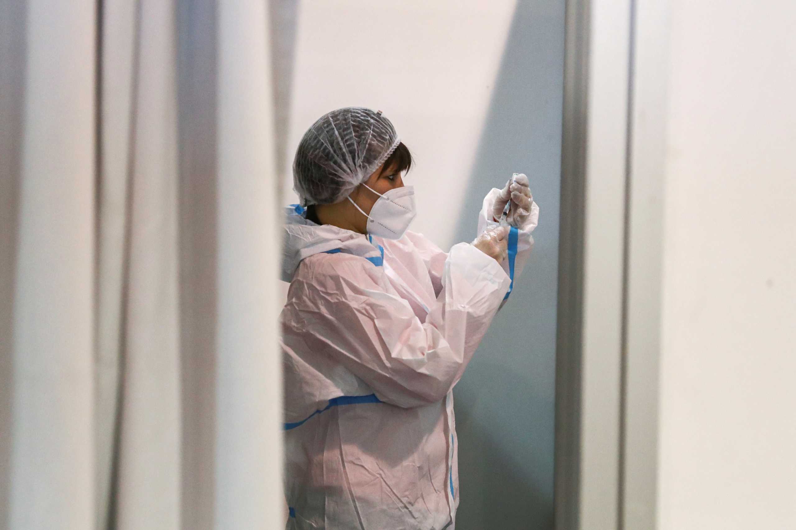 A medical worker fills a syringe with Chinese Sinopharm vaccine for Serbian Army officers as country begins mass vaccination for the coronavirus disease (COVID-19), in Belgrade, Serbia, January 19, 2021. REUTERS