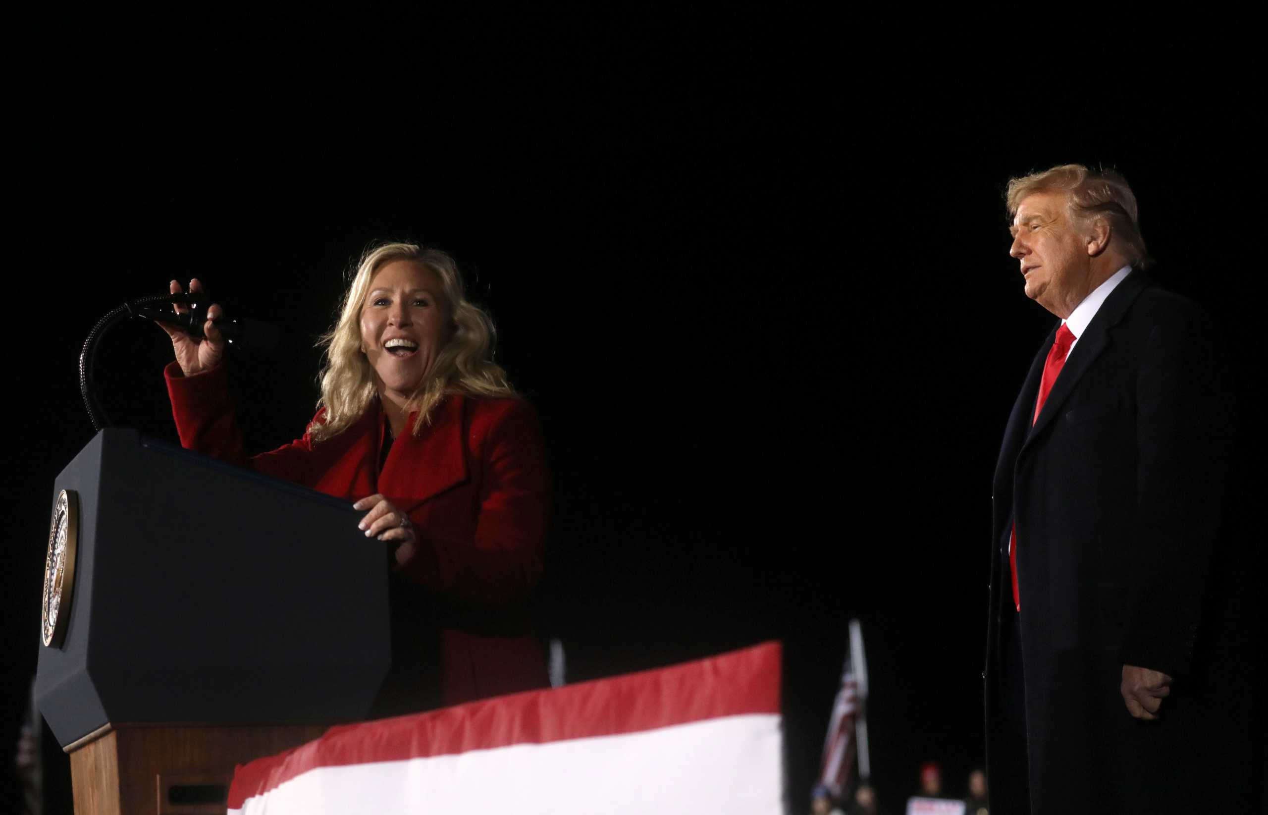 Rep. Marjorie Taylor Greene (R-GA) addresses the crowd next to U.S. President Donald Trump at a campaign rally in Dalton, Georgia, U.S., on the eve of the run-off election to decide both of Georgia's Senate seats January 4, 2021. REUTERS
