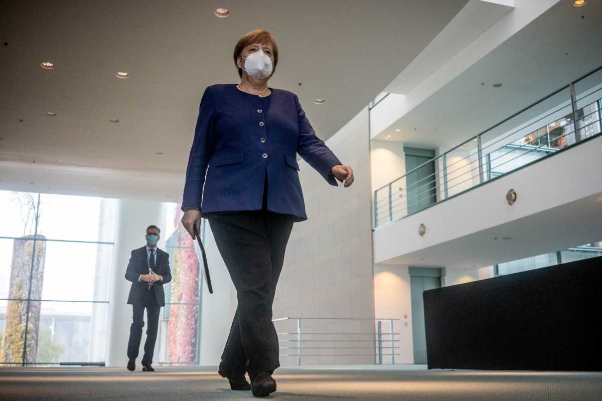 FILE PHOTO: German Chancellor Angela Merkel wears a protective mask as she arrives to give a statement on the outcome of the 2020 U.S. presidential election in Berlin, Germany, November 9, 2020.   Michael Kappeler