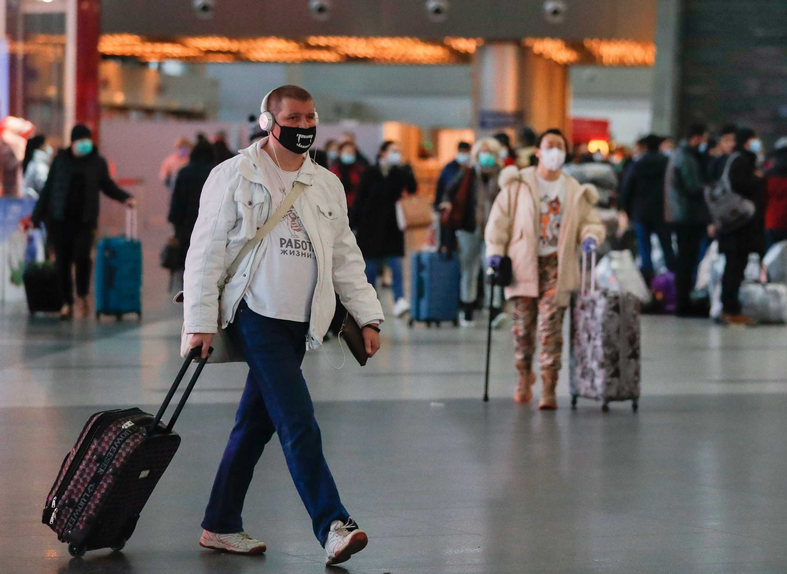A man wearing a protective mask walks at the departure zone of Vnukovo International Airport in Moscow, Russia December 30, 2020. REUTERS