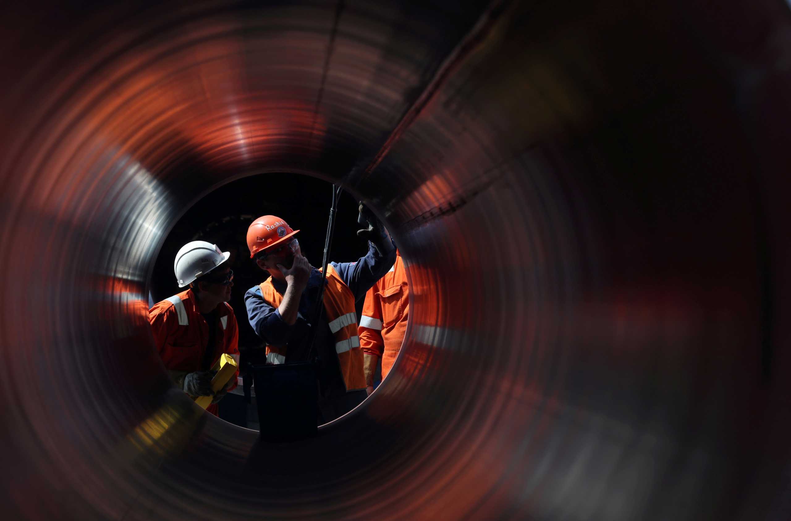 FILE PHOTO: Workers seen through a pipe at the construction site of the Nord Stream 2 gas pipeline, near the town of Kingisepp, Leningrad region, Russia, June 5, 2019. REUTERS