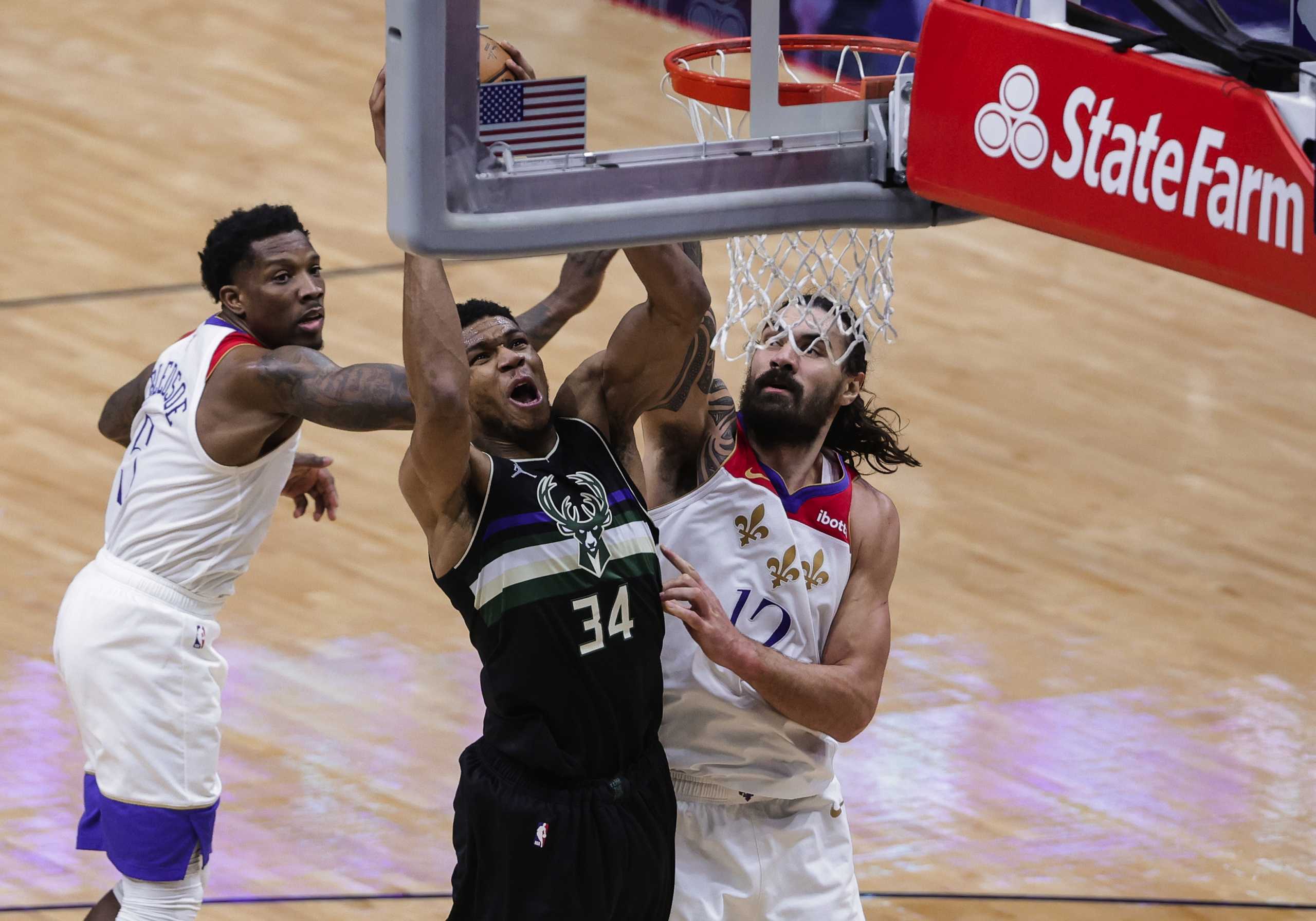 Jan 29, 2021; New Orleans, Louisiana, USA;  Milwaukee Bucks forward Giannis Antetokounmpo (34) shoots as New Orleans Pelicans center Steven Adams (12) and guard Eric Bledsoe (5) defend during the fourth quarter at the Smoothie King Center. Mandatory Credit: Derick E. Hingle-USA TODAY Sports