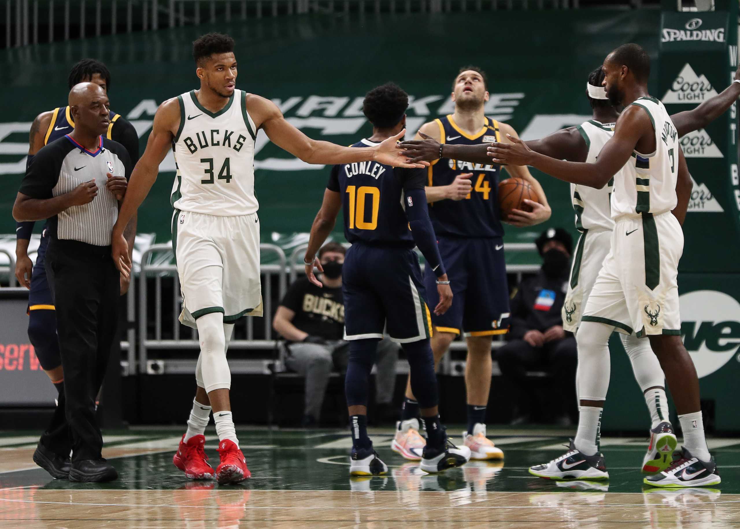 Jan 8, 2021; Milwaukee, WI, USA;  Milwaukee Bucks forward Giannis Antetokounmpo (34) celebrates with forward Khris Middleton (22) against the Utah Jazz at the Bradley Center.  Mandatory Credit: Nick Monroe