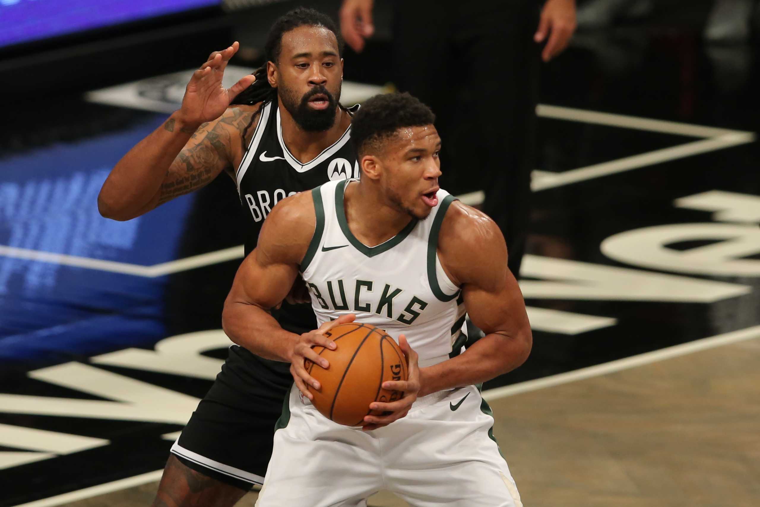 Jan 18, 2021; Brooklyn, New York, USA; Milwaukee Bucks power forward Giannis Antetokounmpo (34) controls the ball against Brooklyn Nets center DeAndre Jordan (6) during the first quarter at Barclays Center. Mandatory Credit: Brad Penner-USA TODAY Sports