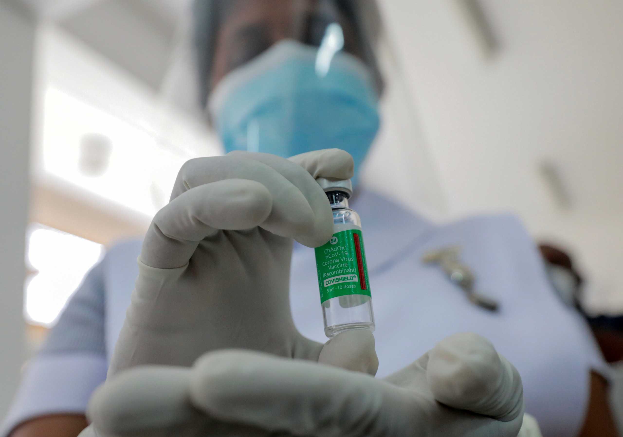 A Health official shows a bottle with a dose of the AstraZeneca's COVID-19 vaccine manufactured by the Serum Institute of India, at Infectious Diseases Hospital in Colombo, Sri Lanka January 29, 2021. REUTERS