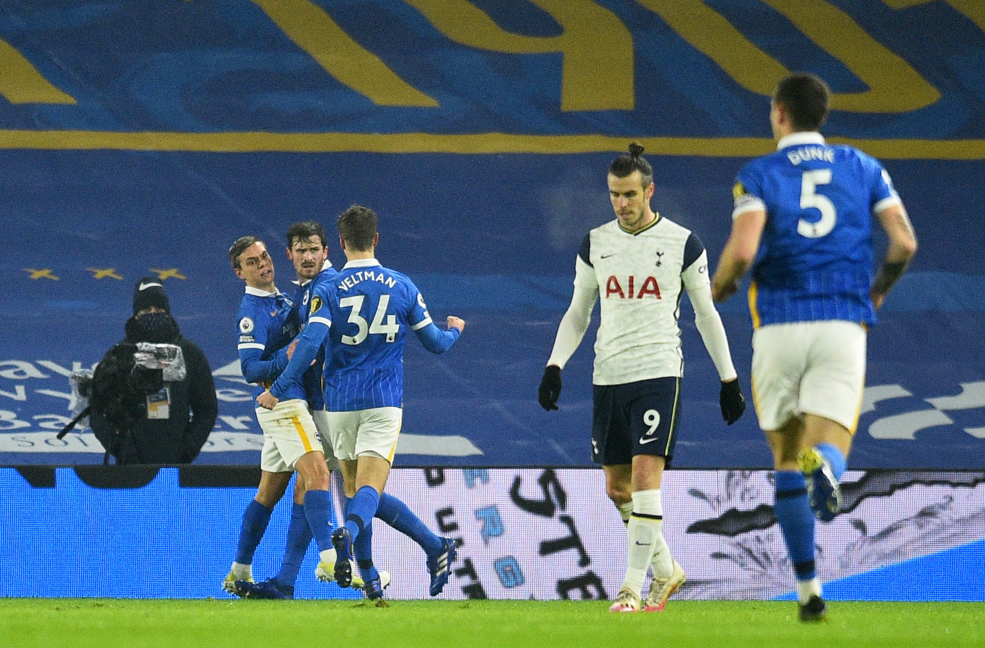 Soccer Football - Premier League - Brighton & Hove Albion v Tottenham Hotspur - The American Express Community Stadium, Brighton, Britain - January 31, 2021 Tottenham Hotspur's Gareth Bale looks dejected as Brighton & Hove Albion's Leandro Trossard celebrates scoring their first goal with teammates Pool via REUTERS