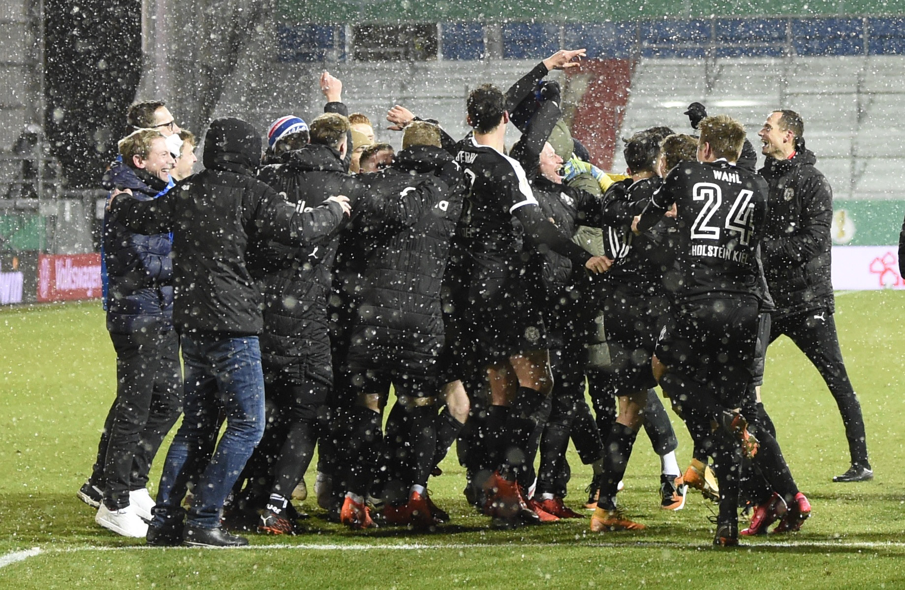 Soccer Football - DFB Cup - Second Round - Holstein Kiel v Bayern Munich - Holstein-Stadion, Kiel, Germany - January 13, 2021 Holstein Kiel players celebrate after winning the penalty shootout REUTERS