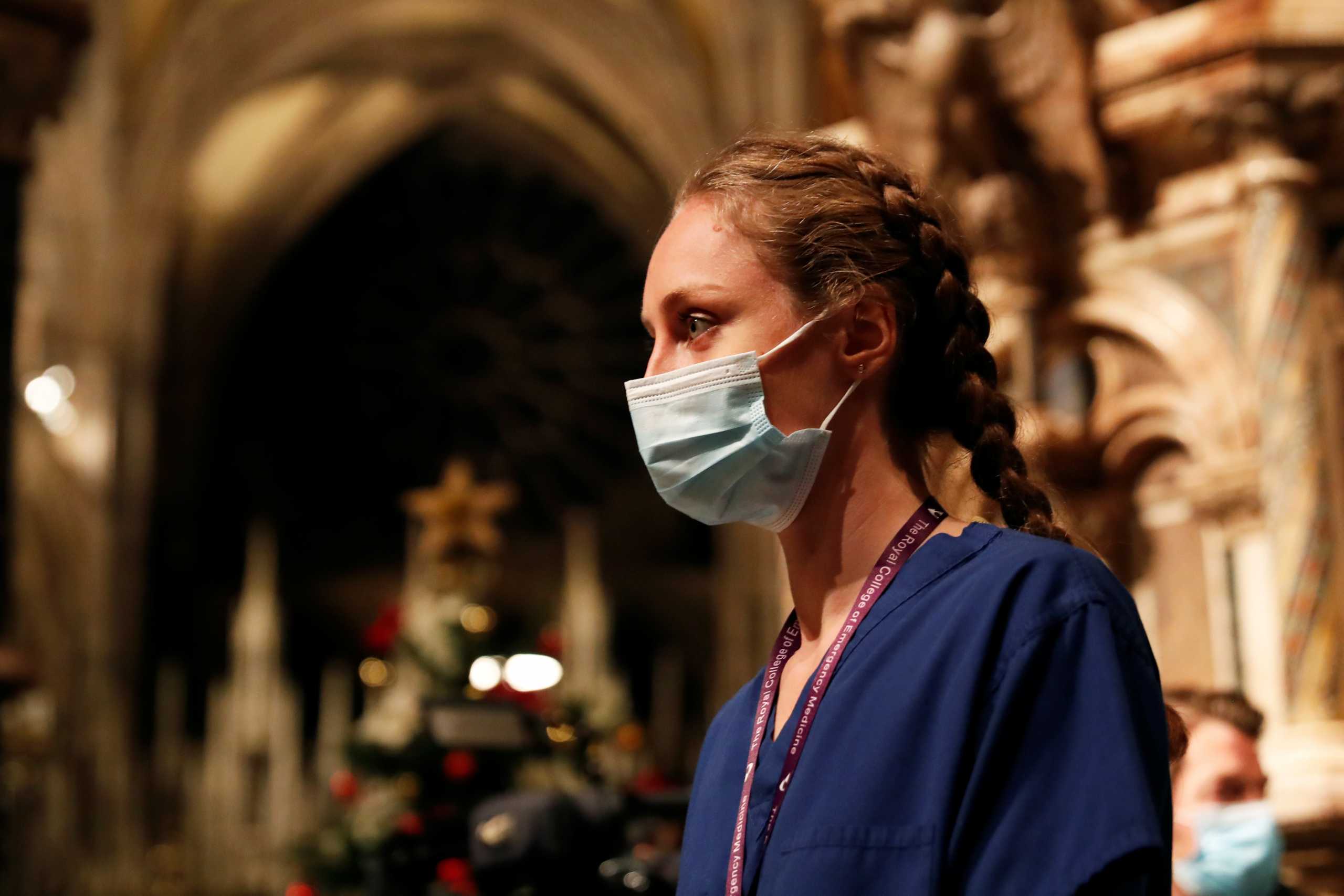 Dr Tara Watkiss of NHS University Hospital of North Durham, wearing a protective mask, is seen after lighting the Christmas tree during The Lighting of the Christmas Tree and Blessing of the Crib, which is live-streamed online due to the coronavirus disease (COVID-19) outbreak, at Durham Cathedral in Durham, Britain, December 13, 2020. REUTERS