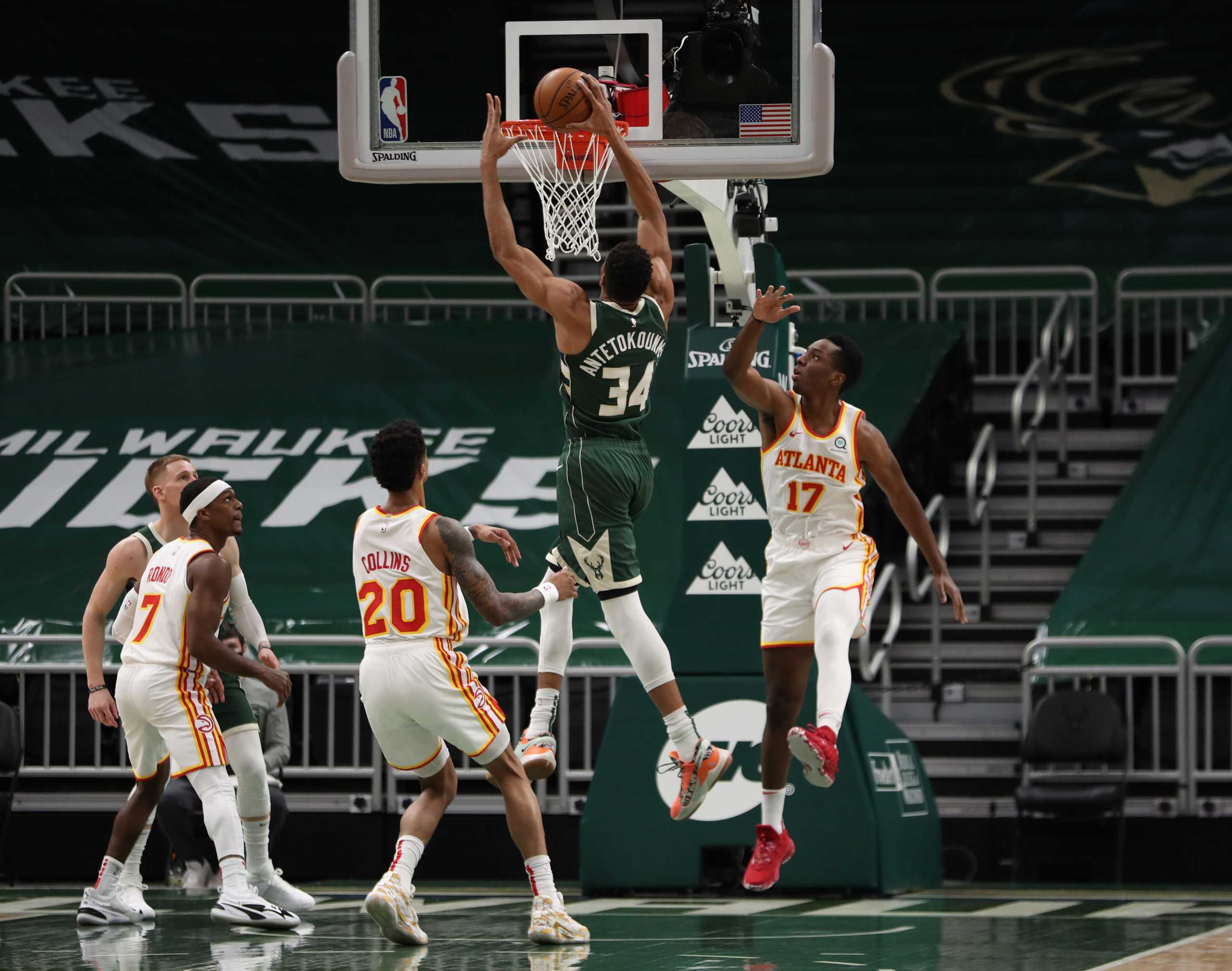 Jan 24, 2021; Milwaukee, WI, USA;  Milwaukee Bucks forward Giannis Antetokounmpo (34) shoots against Atlanta Hawks forward Onyeka Okongwu (17) and forward John Collins (20) at the Bradley Center.  Mandatory Credit: Nick Monroe