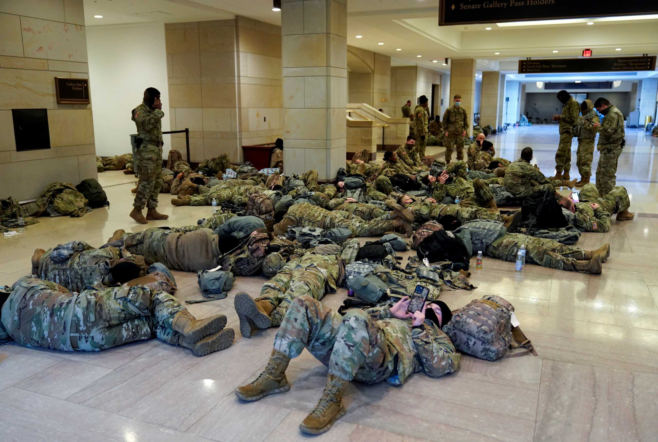 National Guard members sleep in the Capitol Vistor's Center on Capitol Hill before Democrats begin debating one article of impeachment against U.S. President Donald Trump at the U.S. Capitol, in Washington, U.S., January 13, 2021. REUTERS