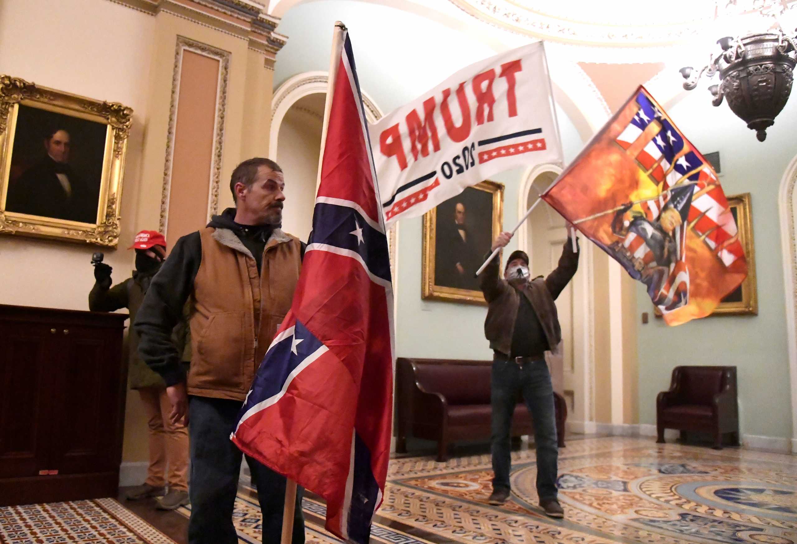 Supporters of U.S. President Donald Trump demonstrate on the second floor of the U.S. Capitol near the entrance to the Senate after bre?ching security defenses, in Washington, U.S., January 6, 2021.         REUTERS