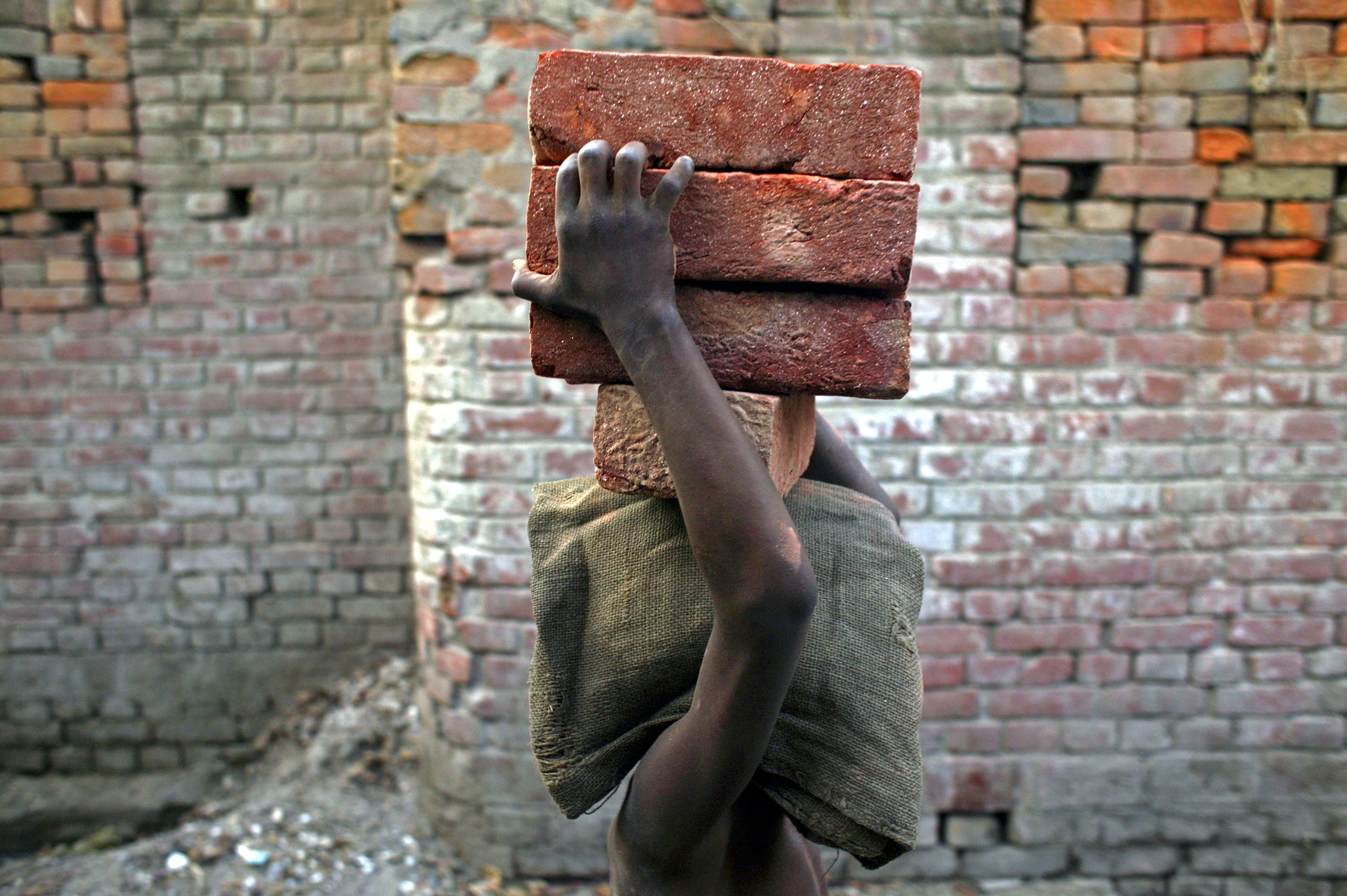 A child labourer carries bricks in Bihar-e-Sharif town, about 60 km (37 miles) from Patna April 9, 2007. REUTERS