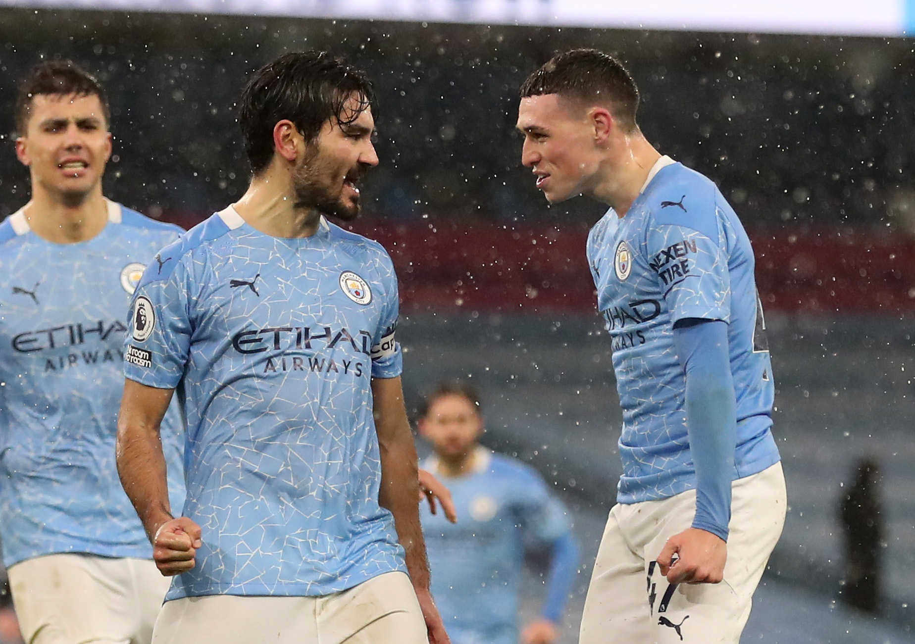Soccer Football - Premier League - Manchester City v Aston Villa - Etihad Stadium, Manchester, Britain - January 20, 2021 Manchester City's Ilkay Gundogan celebrates scoring their second goal with Phil Foden Pool via REUTERS