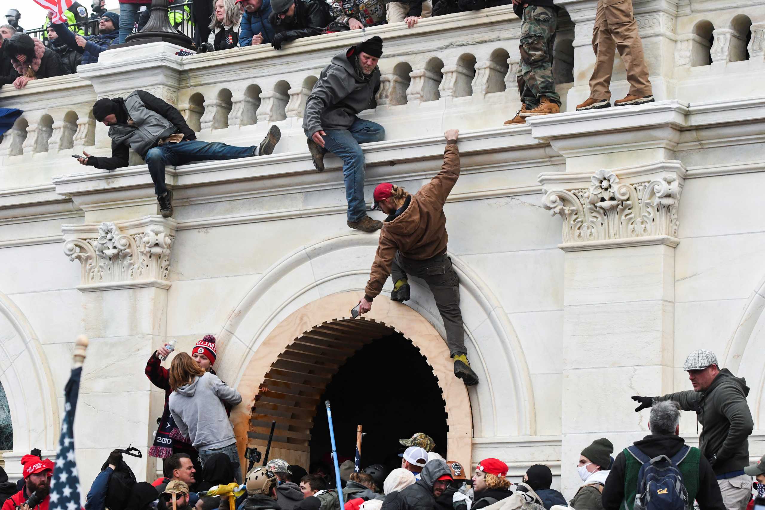 Supporters of U.S. President Donald Trump climb on walls at the U.S. Capitol during a protest against the certification of the 2020 U.S. presidential election results by the U.S. Congress, in Washington, U.S., January 6, 2021. REUTERS