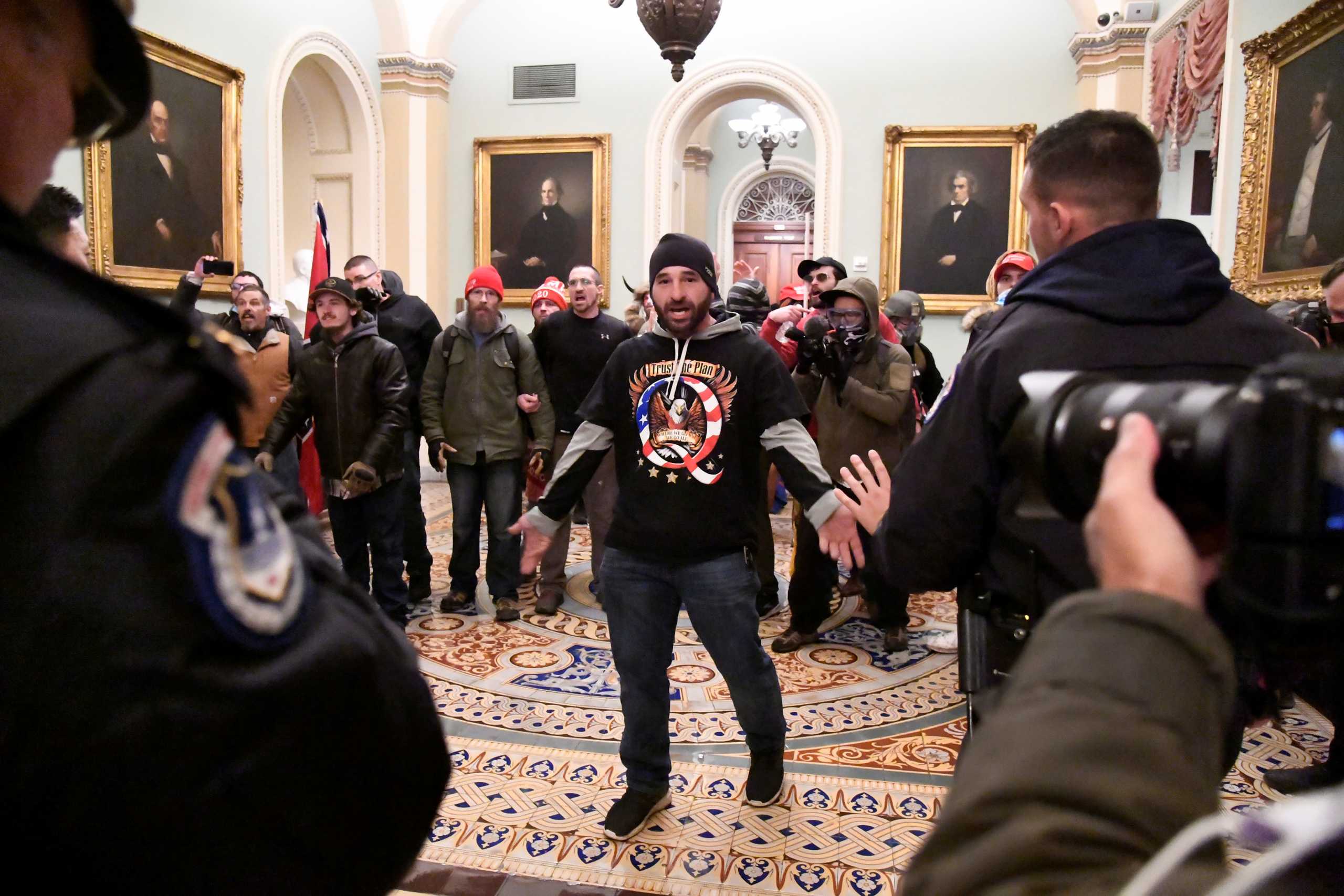 A supporter of President Donald Trump confronts police as Trump supporters demonstrate on the second floor of the U.S. Capitol near the entrance to the Senate after breaching security defenses, in Washington, U.S., January 6, 2021.         REUTERS